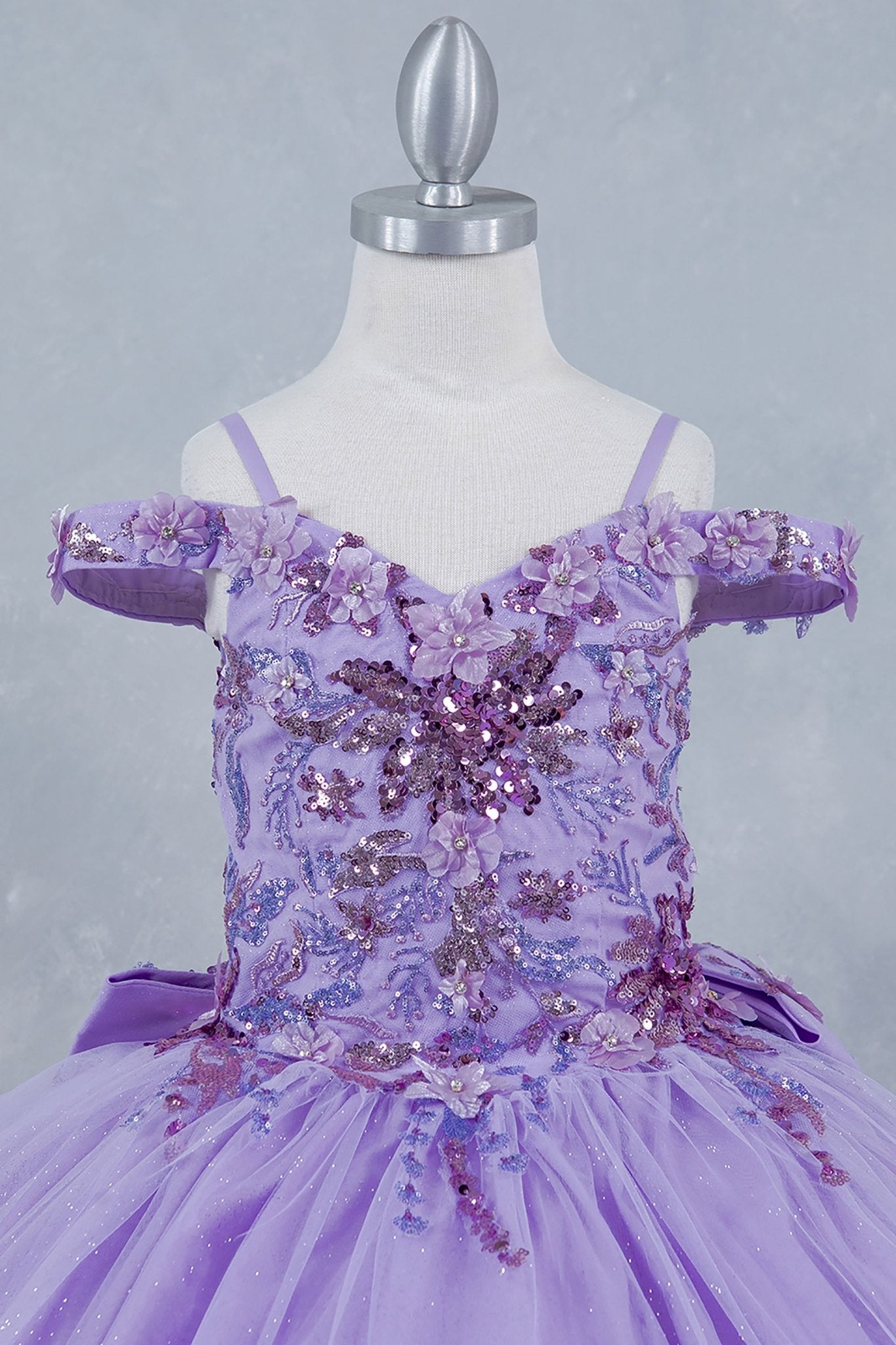 Lilac front view kids mini quinceañera mini quince dress with off-shoulder 3D beaded floral applique and glitter tulle train.