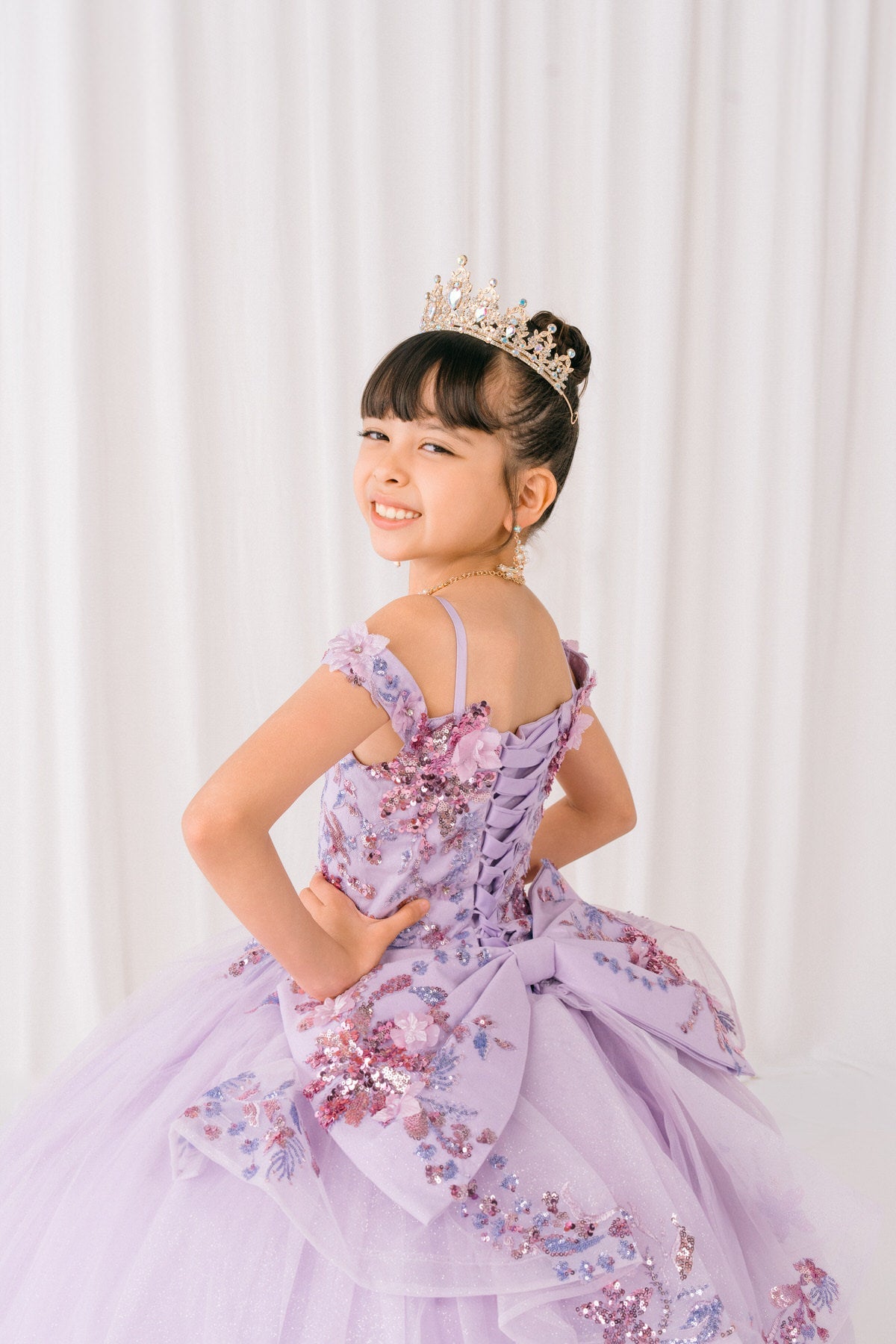 Lilac back view kids mini quinceañera mini quince dress with off-shoulder 3D beaded floral applique, glitter tulle and train.