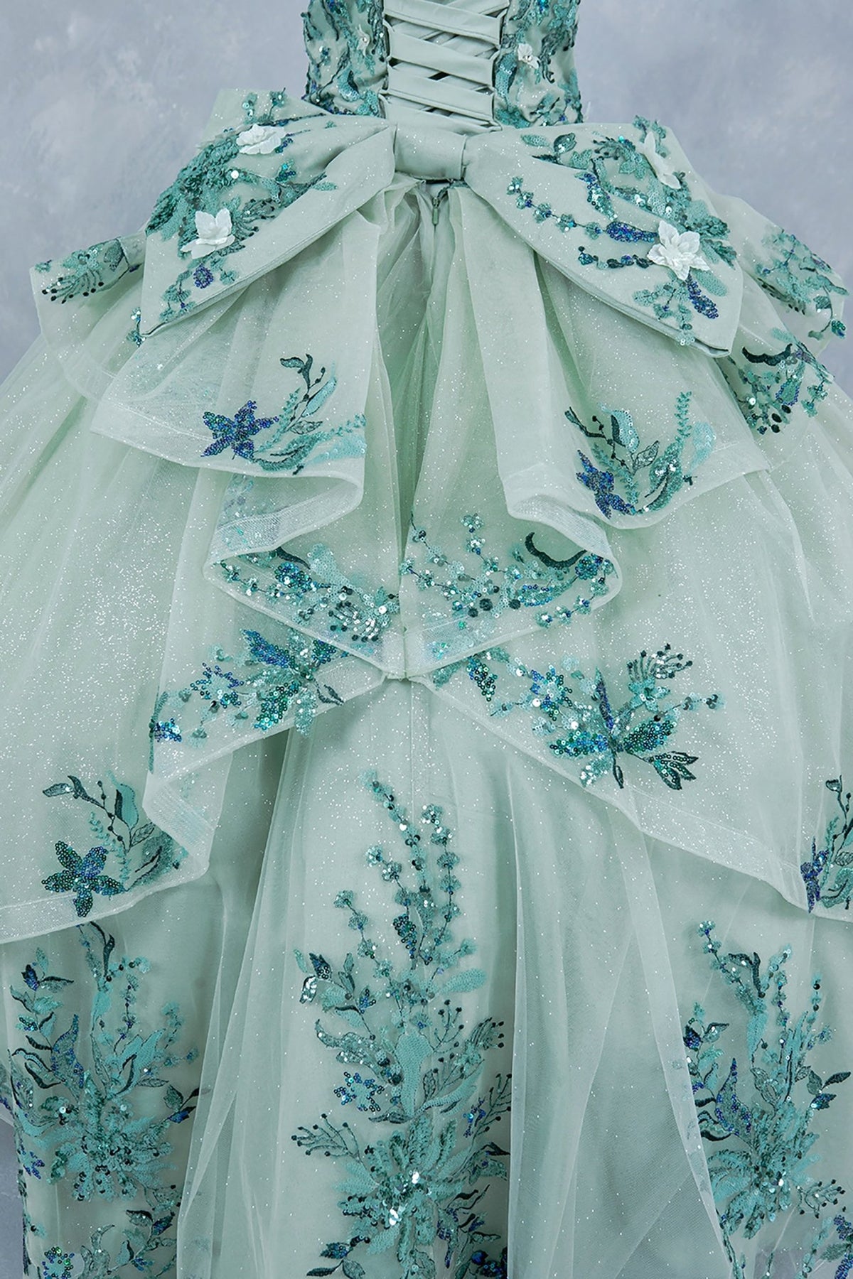 Sage back skirt view kids mini quinceañera mini quince dress with off-shoulder 3D floral applique, glitter tulle and train.