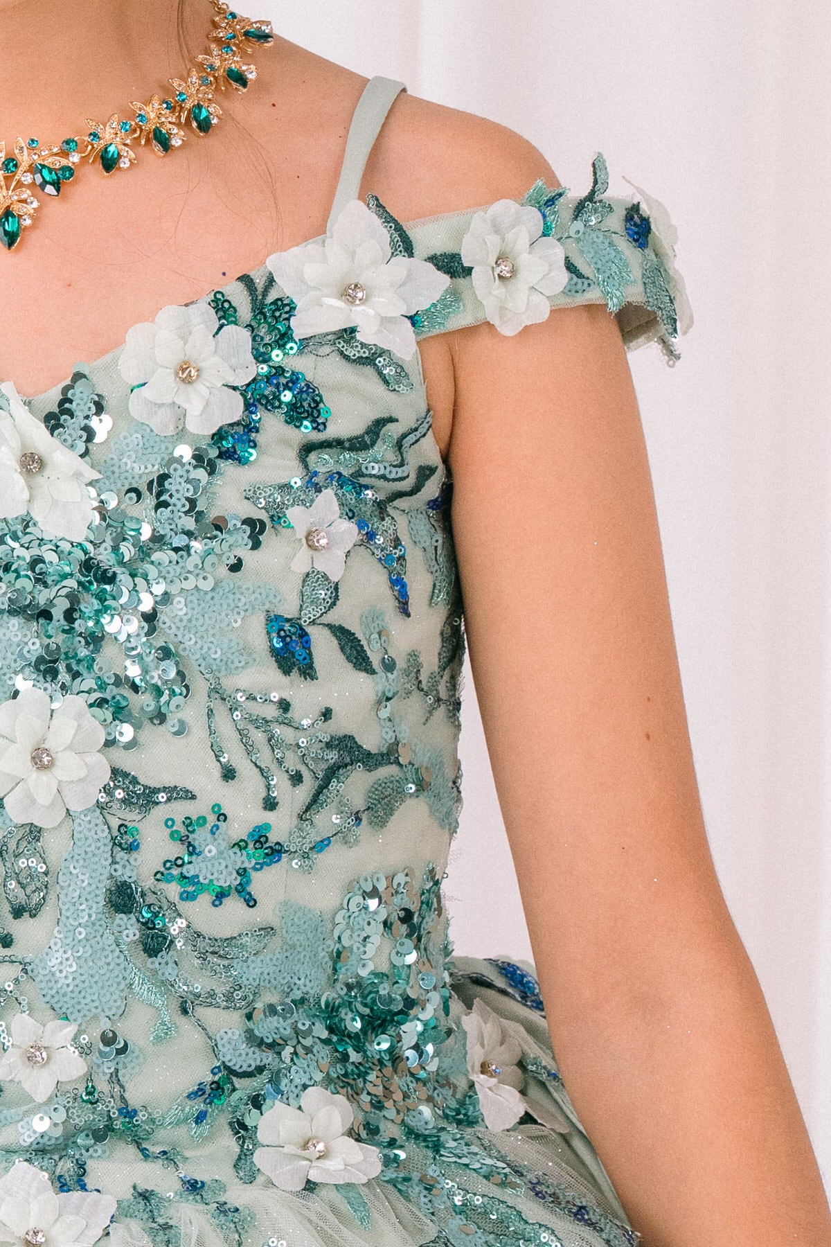Sage detail zoom kids mini quinceañera mini quince dress with floral lace, butterfly embellishments and glitter tulle fabric.