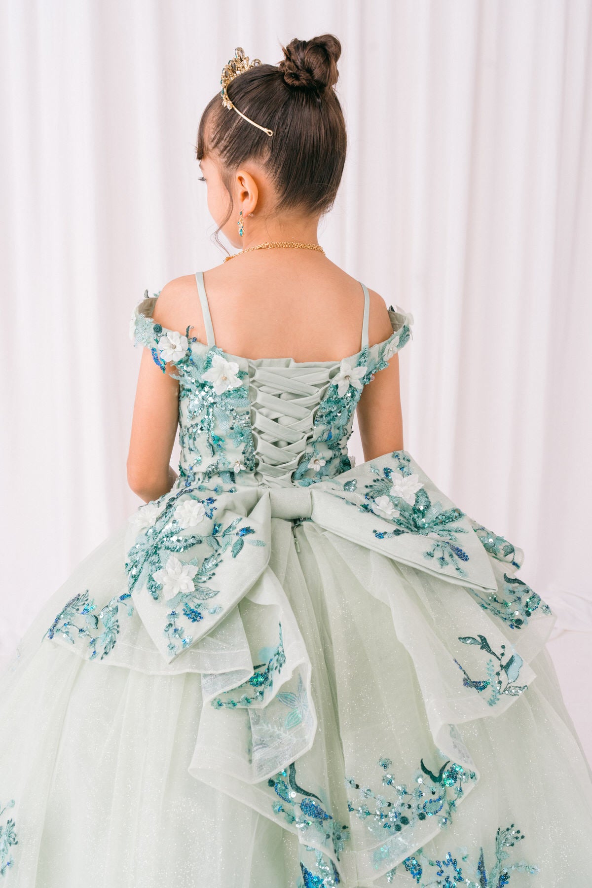 Sage front view kids mini quinceañera mini quince dress with floral lace and glitter tulle train.