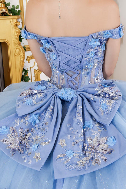 Close-up back view of a woman wearing blue quinceanera ball gown with lace-up corset, oversized bow, and seven-layer tulle skirt