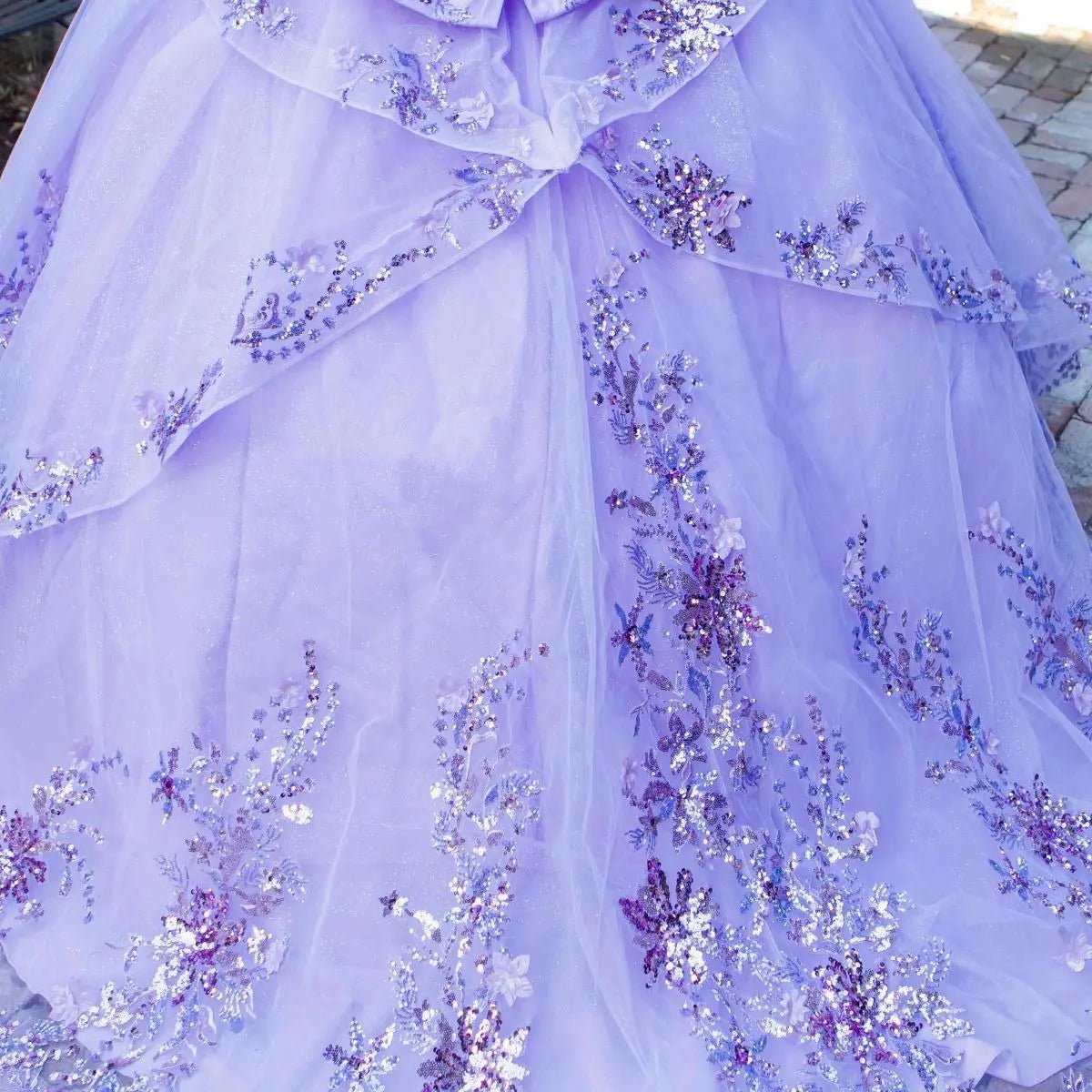 Skirt Detail of lilac quinceanera ball gown with seven-layer tulle skirt and floral beaded appliques