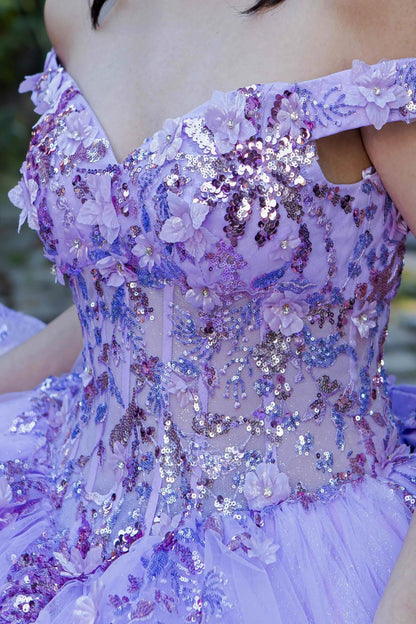 Zoomed front view of a woman wearing lilac quinceanera ball gown with seven-layer tulle skirt, floral beaded appliques, and rhinestone detailing