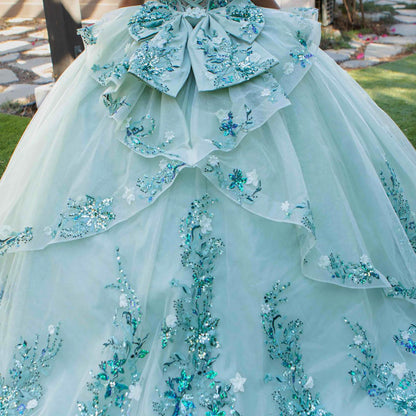 Close-up of sage quinceanera ball gown tulle fabric with floral beaded appliques and layered detailing