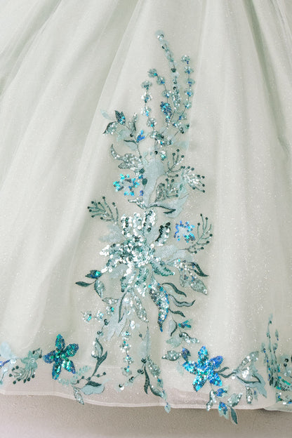 Close-up of a white fabric with green floral embroidery