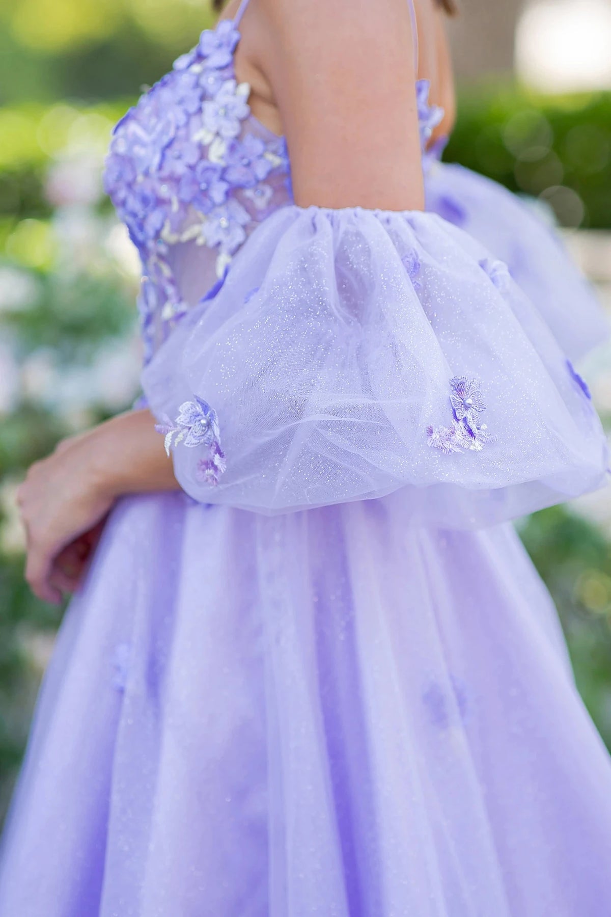 Detailed view highlights lilac prom dress styled with optional detachable puff sleeves.