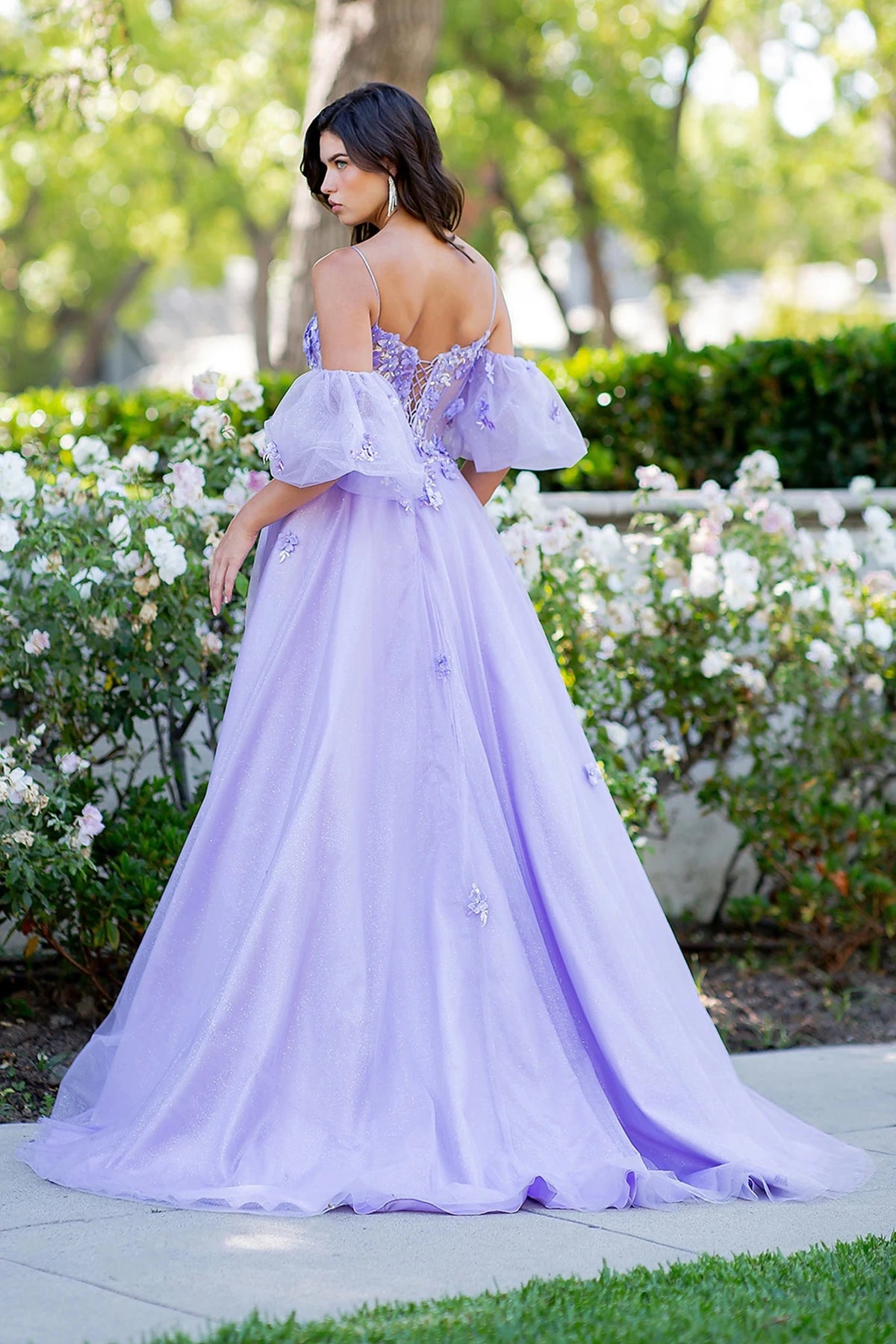 Rear view reveals lilac prom dress designed with lace-up spaghetti back and zipper closure.