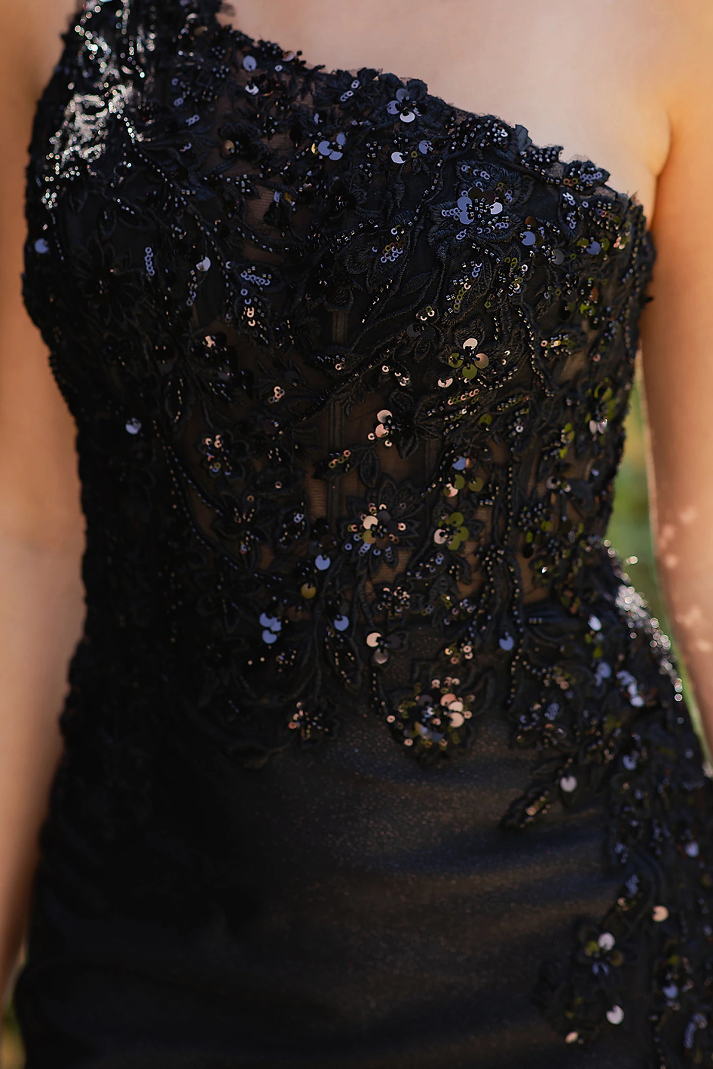 Black prom dress featuring beadwork and sequins across bodice