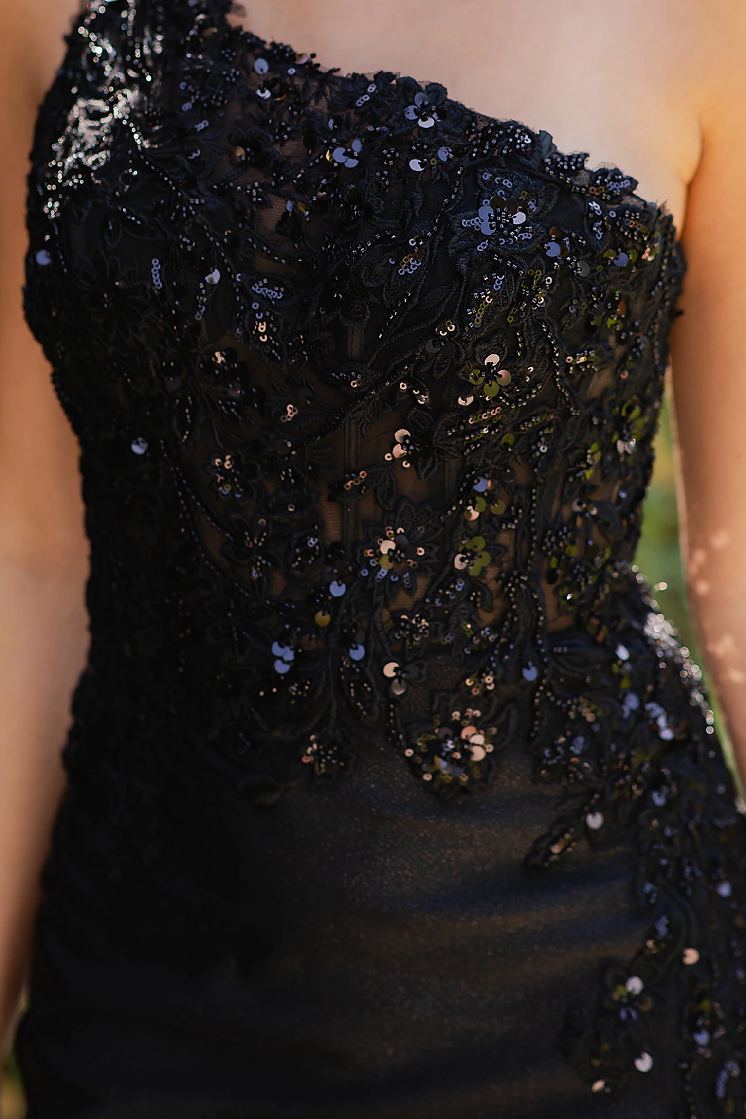 Black prom dress featuring beadwork and sequins across bodice