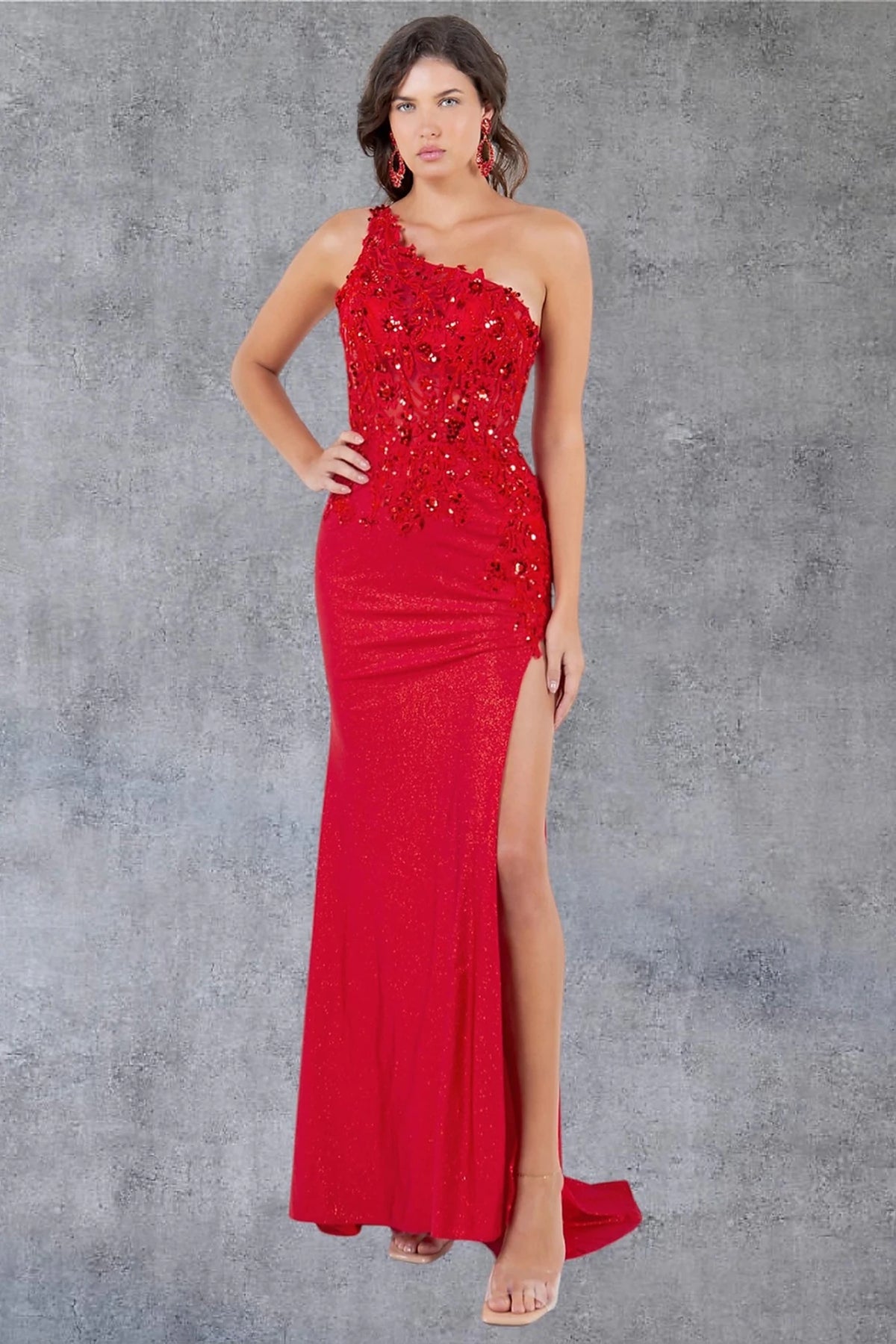 Bodice close-up highlights red prom dress with one-shoulder bodice and asymmetrical neckline.