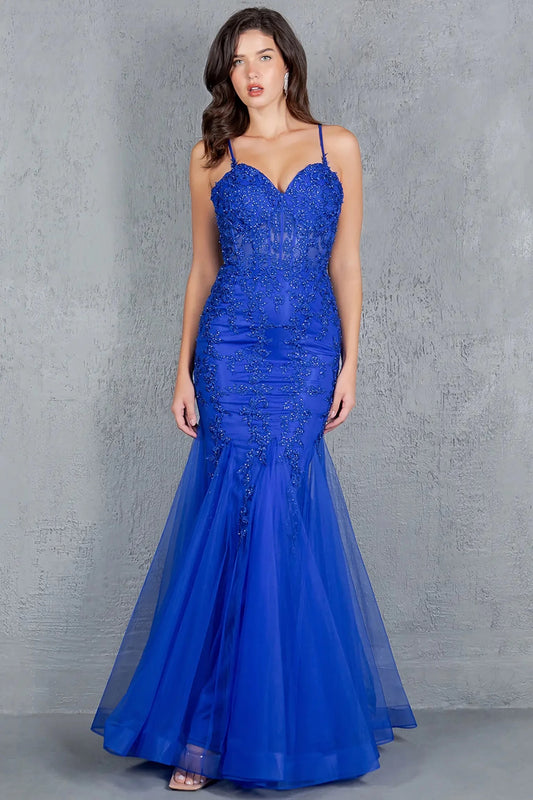 A full-length view of a woman wearing blue formal dress with lace-up corset closure.