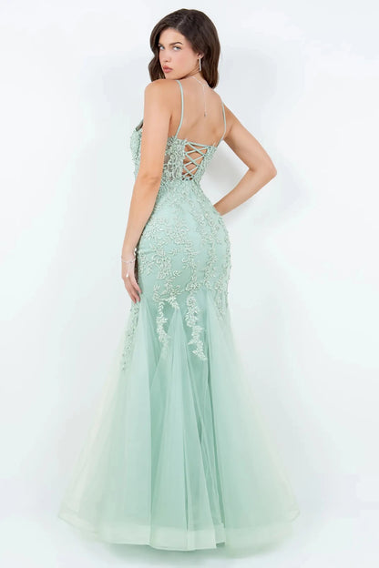 A side profile view of a woman wearing a sage mermaid prom dress, showcasing the sculpted silhouette and flare.