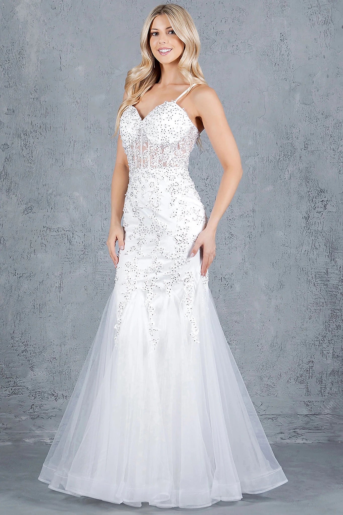 Off White mermaid gown showcasing tulle overlay flaring from hips into mermaid silhouette