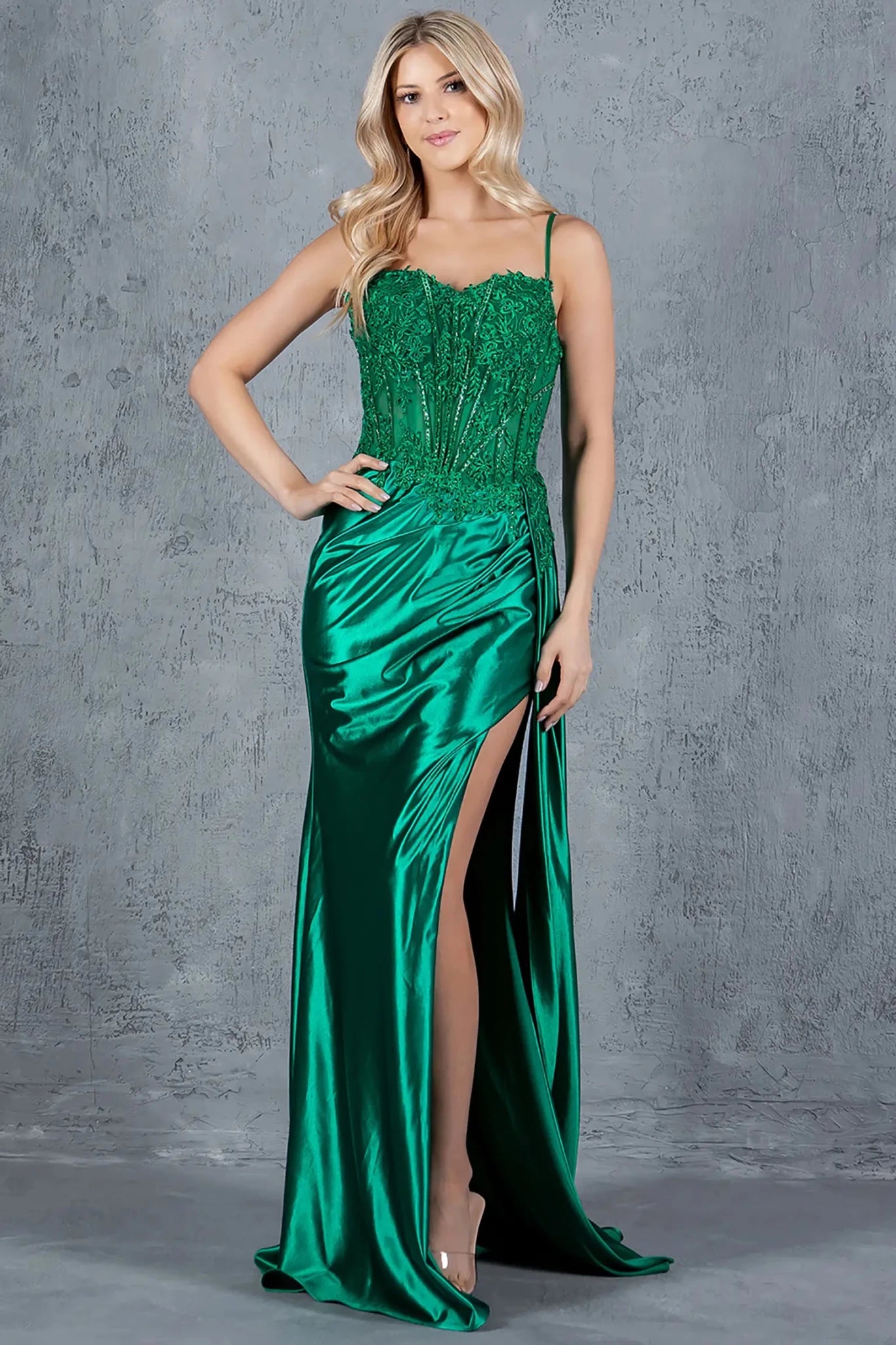 Full front view of a women wearing green lace corset prom dress with sweetheart neckline and slit.