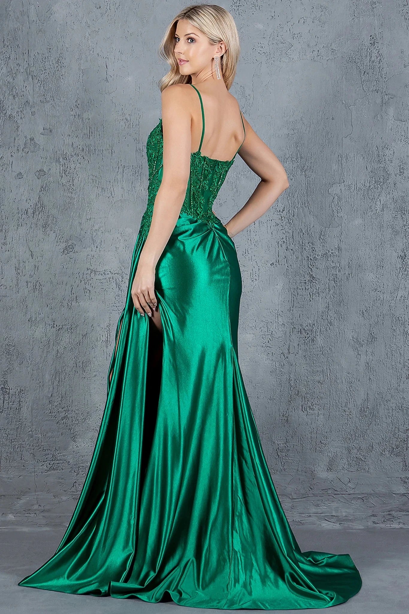 Green prom dress completed with dramatic train extending from back of skirt