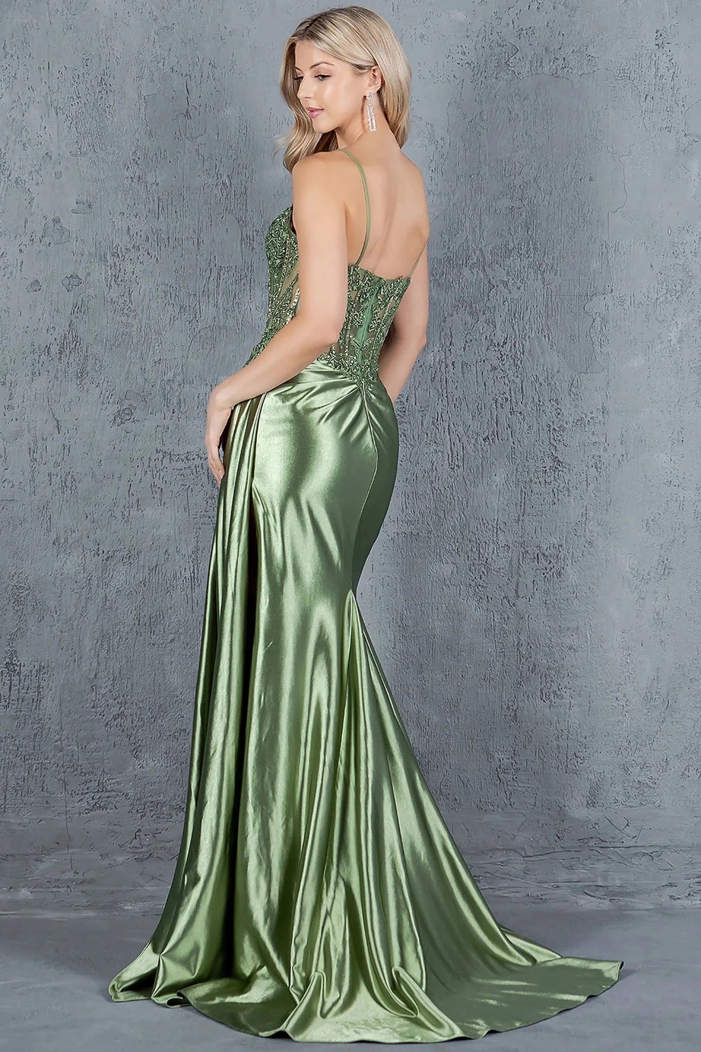 Sage prom dress completed with dramatic train extending from back of skirt