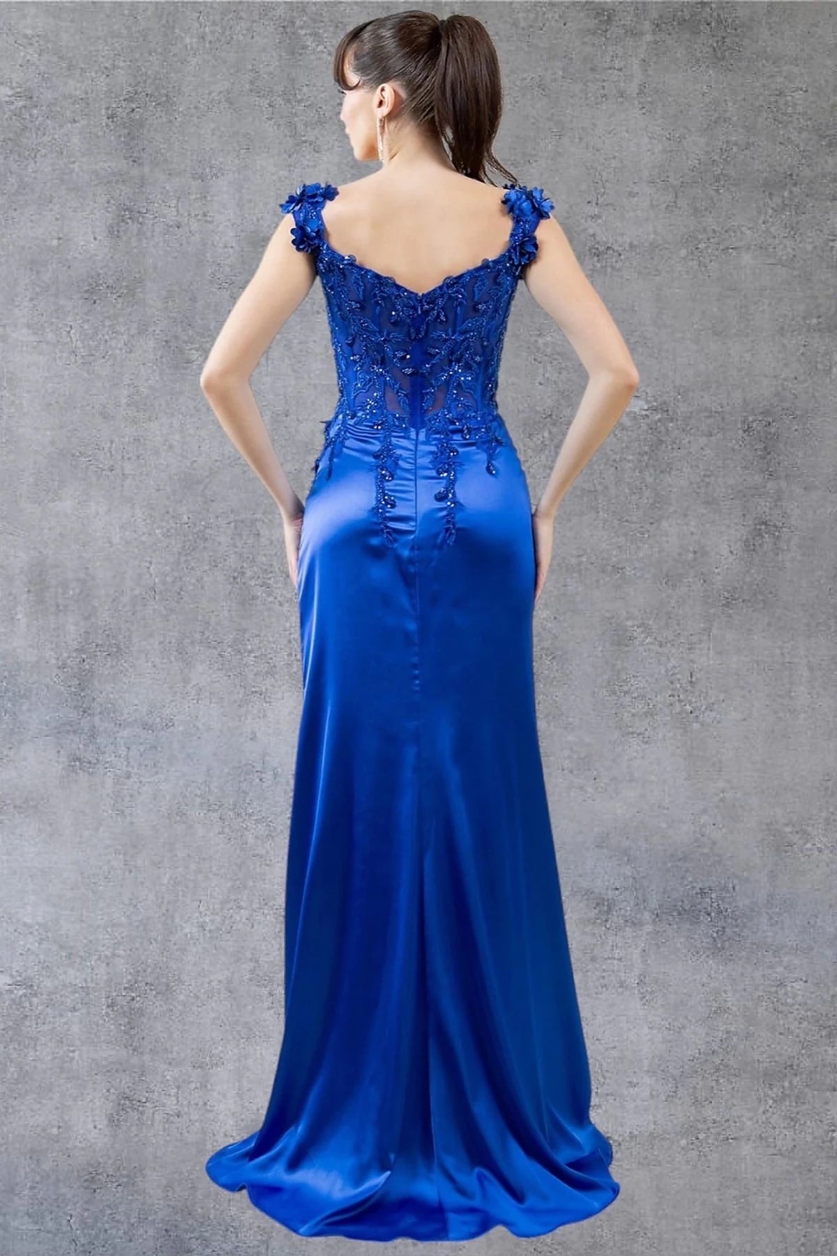 Rear view reveals royal blue evening dress designed with zipper back closure.