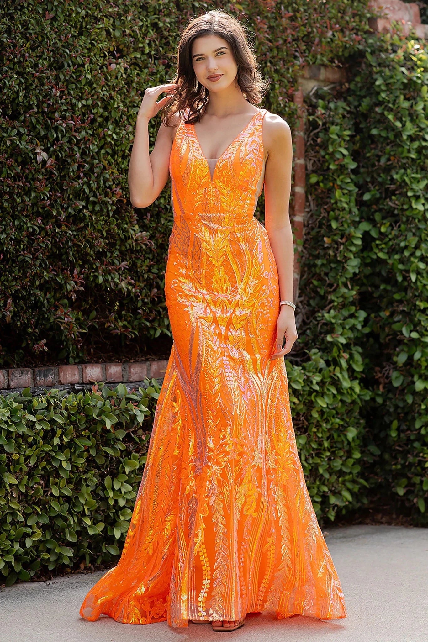 Orange prom dress featuring sequined embroidery in botanical motifs