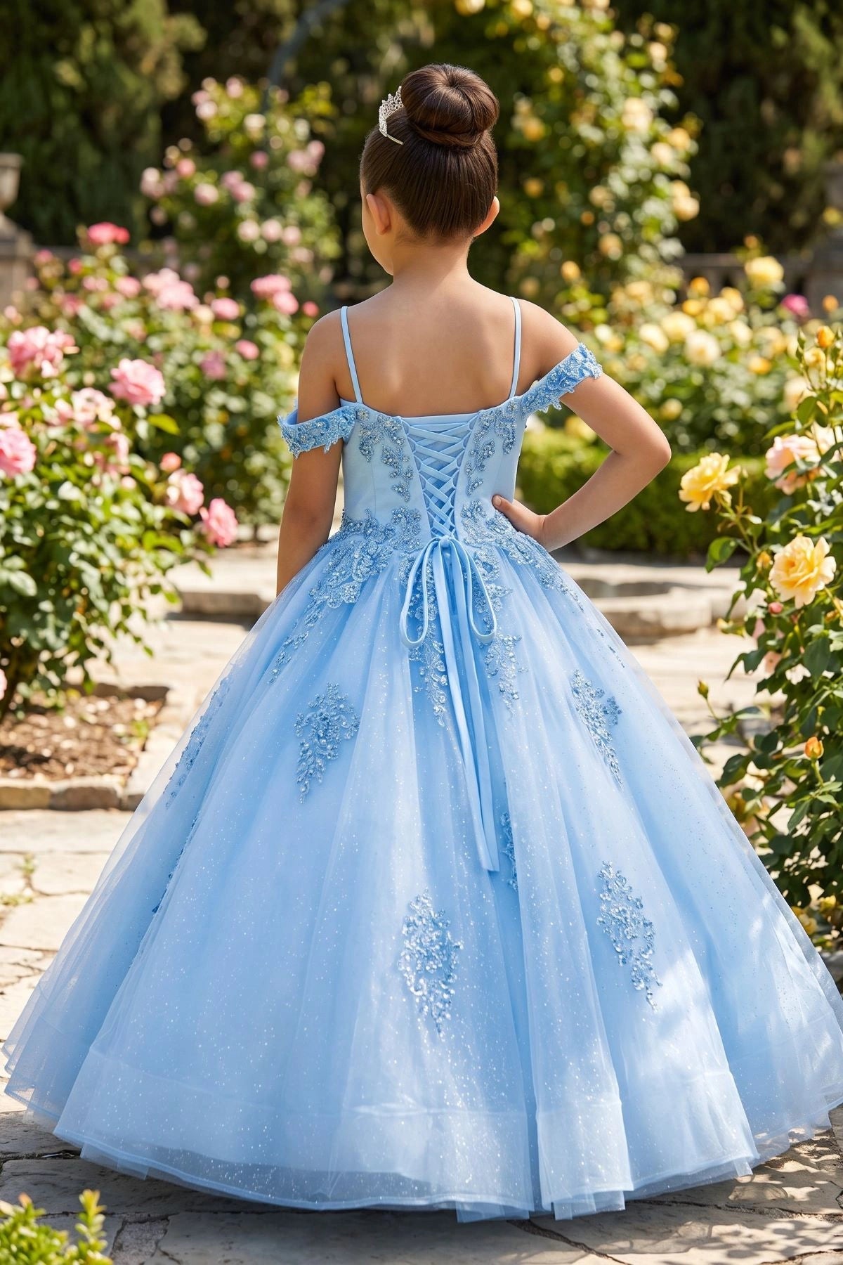 Displayed in a back view, the Blue mini quince dress has lace-up closure and sheer tulle skirt.