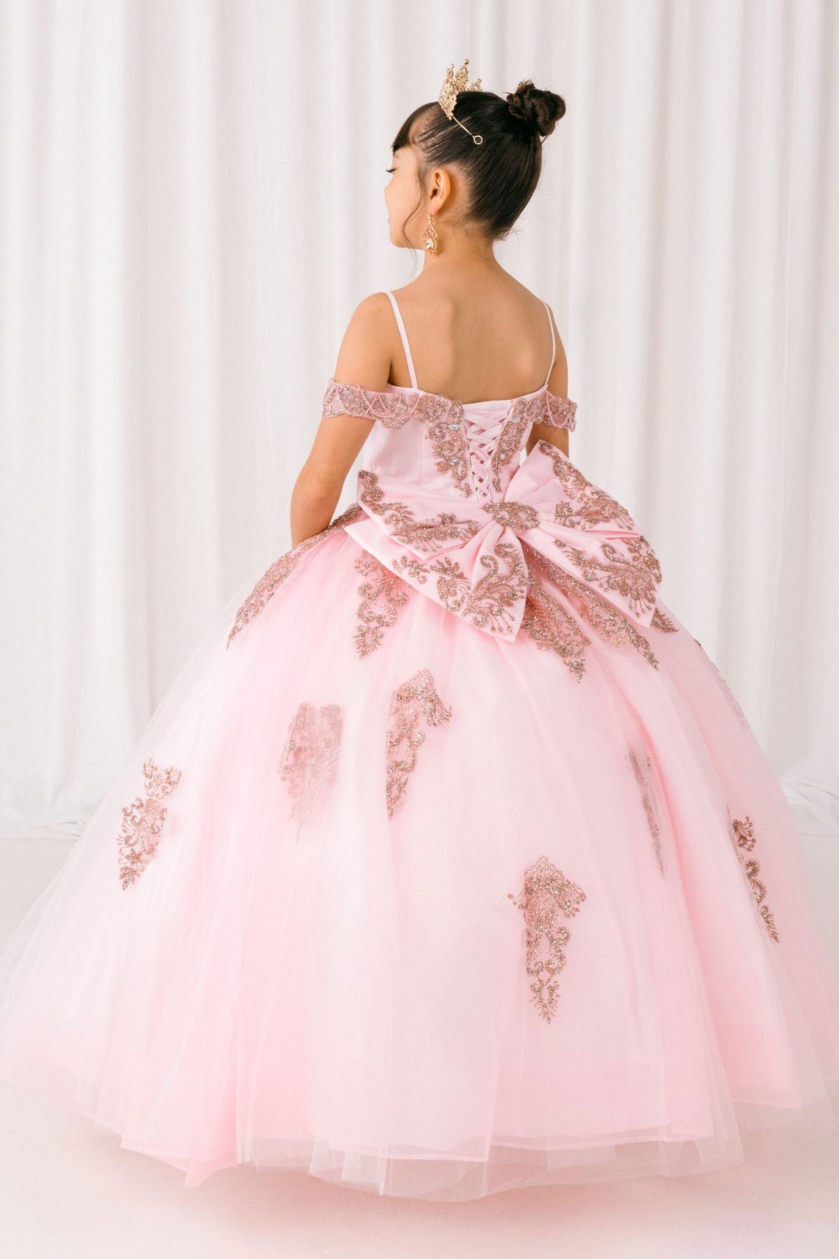 Pink front view kids mini quinceañera mini quince dress with sparkle bead details, gold embroidery and layered tulle skirt.