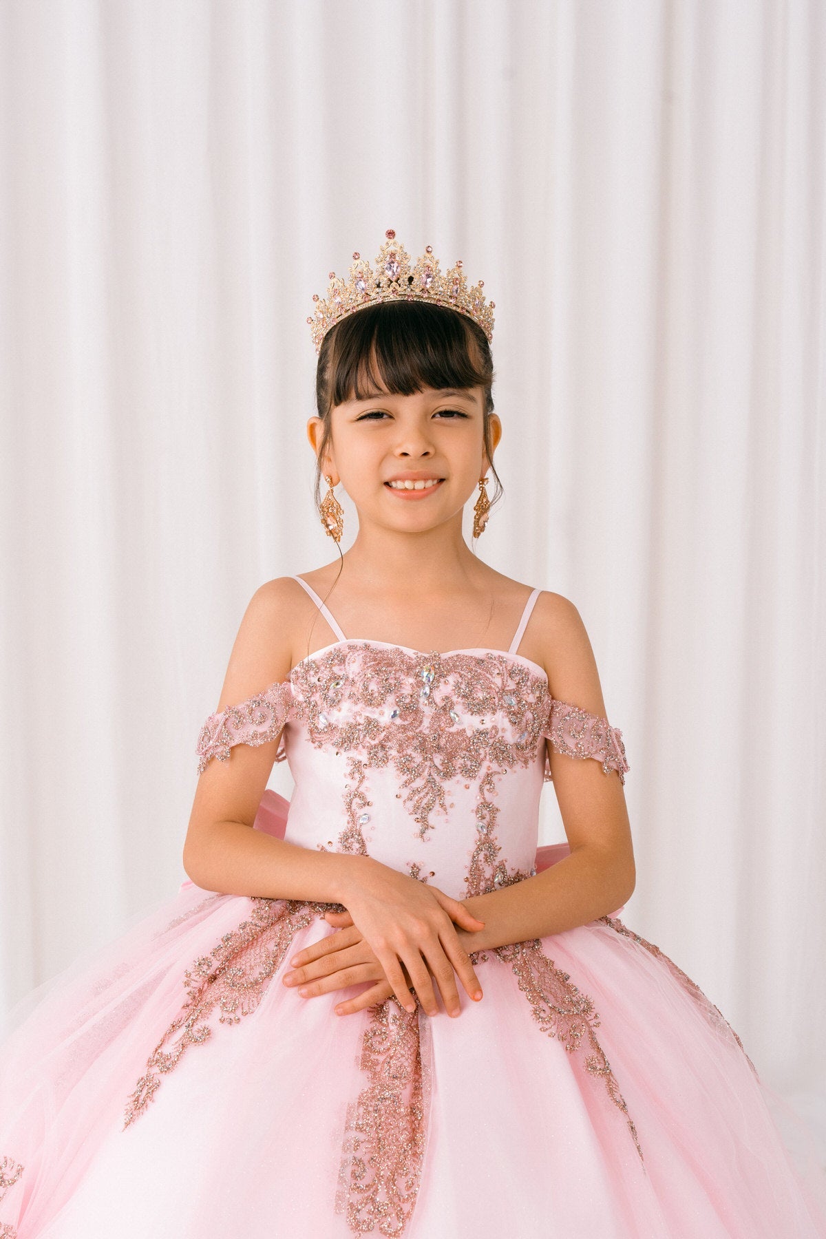 Pink front view kids mini quinceañera mini quince dress with sparkle bead details and layered tulle skirt.