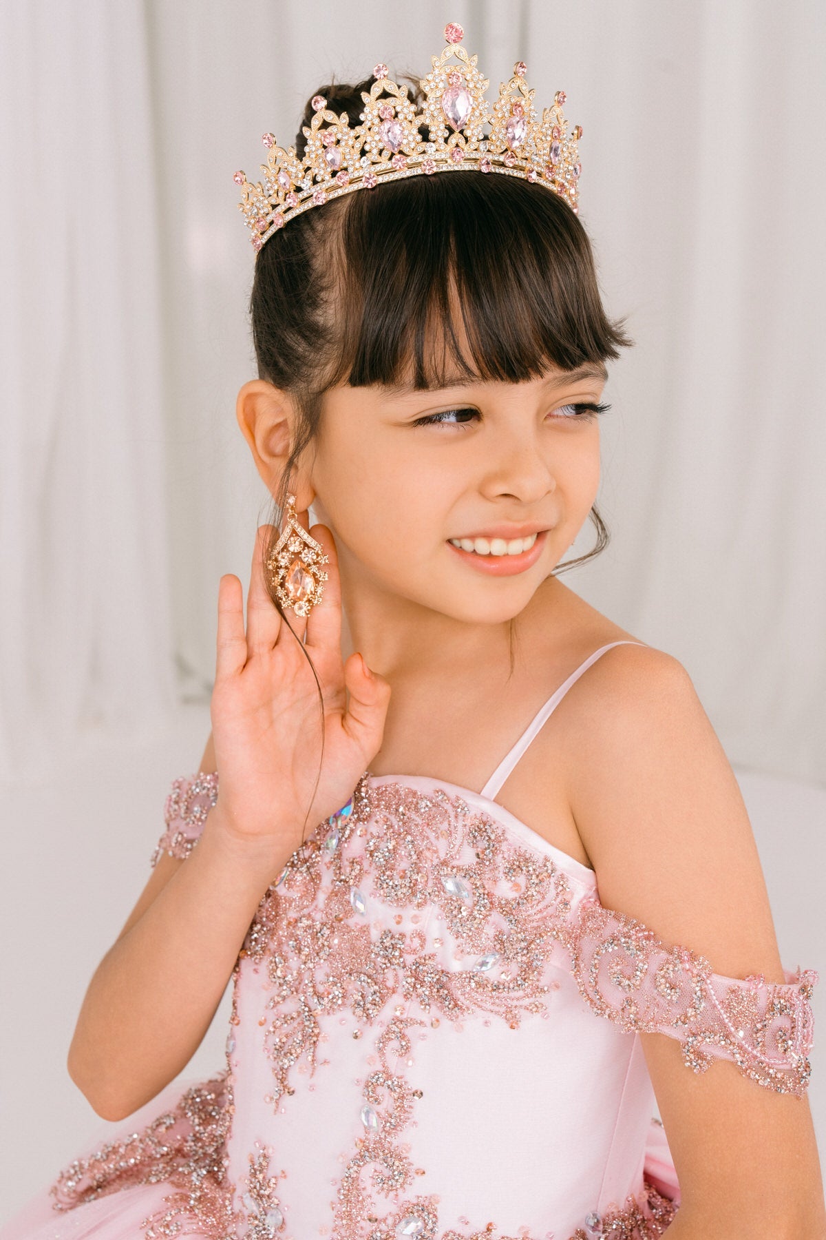 Pink front view kids mini quinceañera mini quince dress with sparkle bead details and layered tulle skirt.