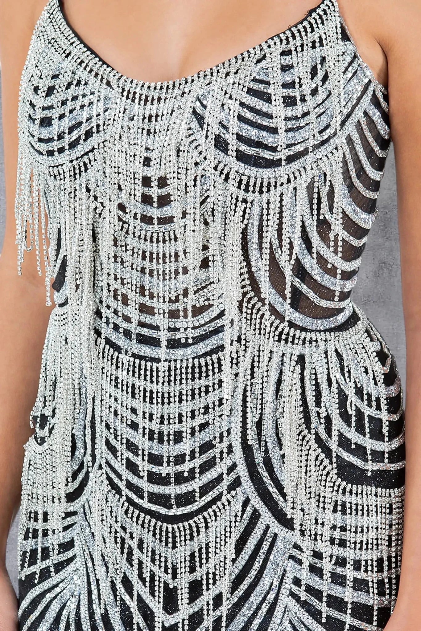 Black evening gown featuring beaded fringe details across bodice and skirt