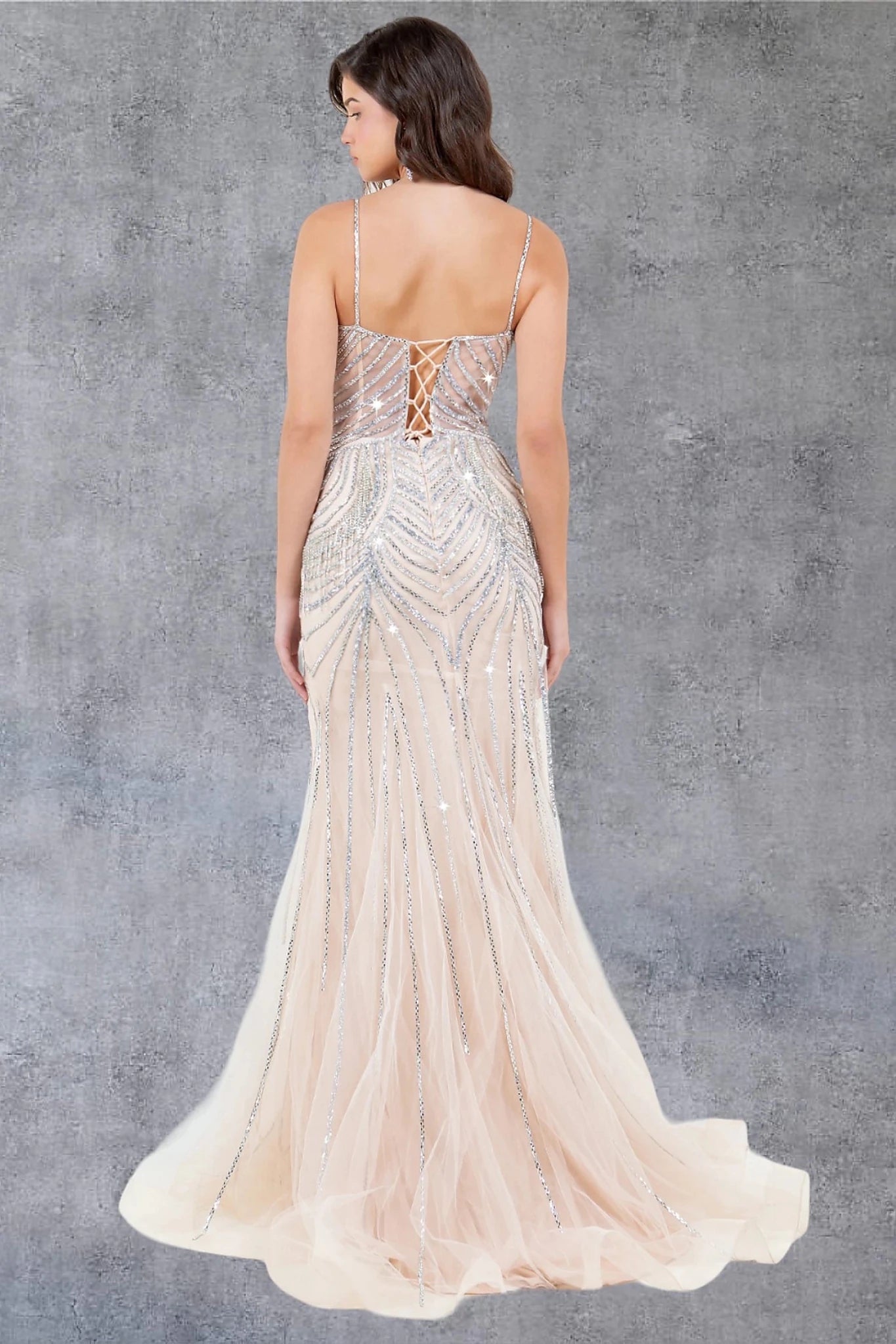 Nude evening gown showcasing lace-up back closure with zipper for secure fit