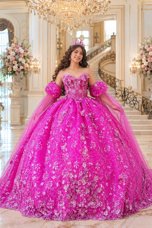 Shown in a front view, the Fuchsia quinceañera dress has floral embellished bodice and sheer puff sleeves over the ball skirt.