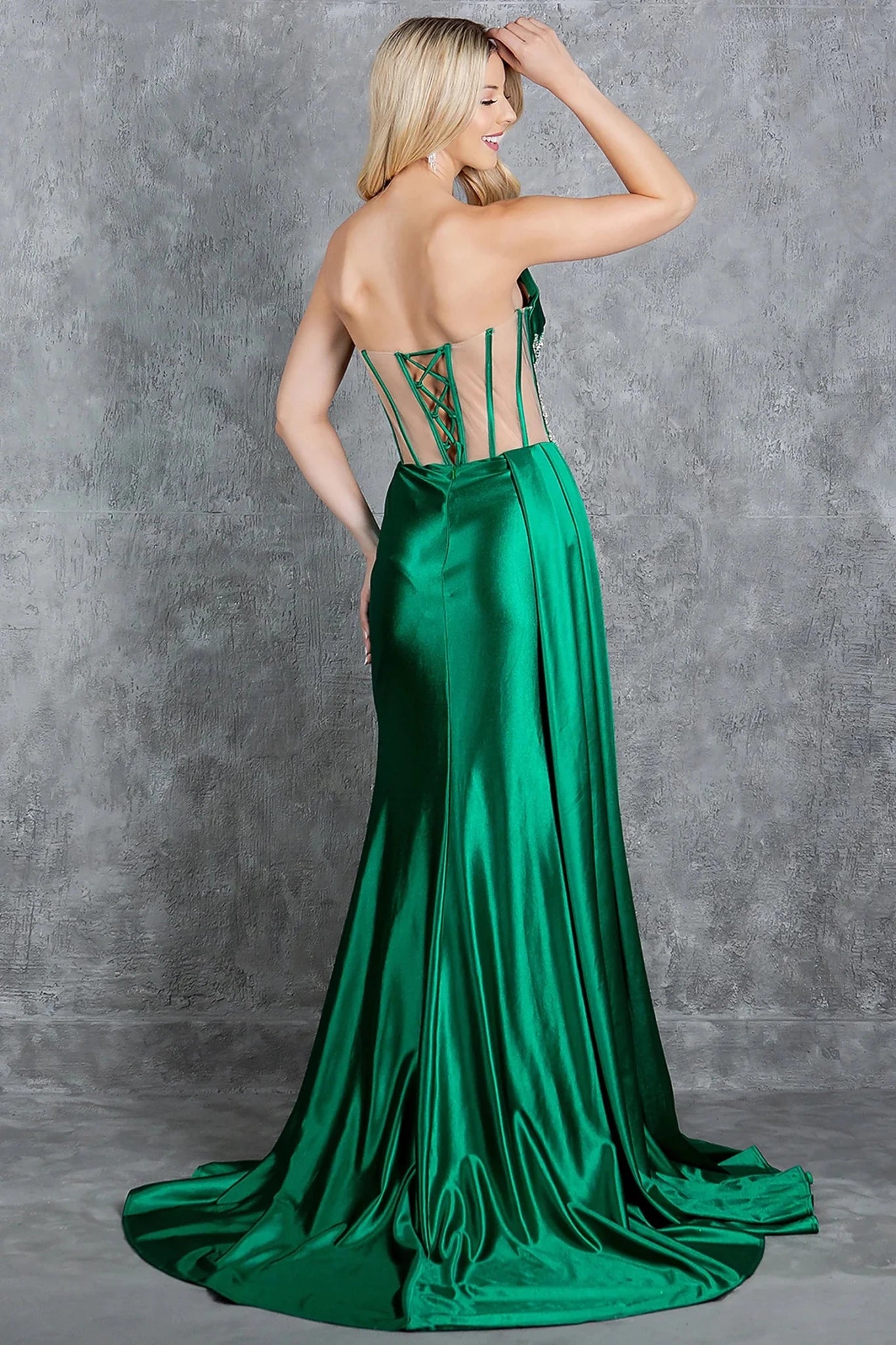 Emeral Green prom dress styled with sheer cutout details creating corset appearance