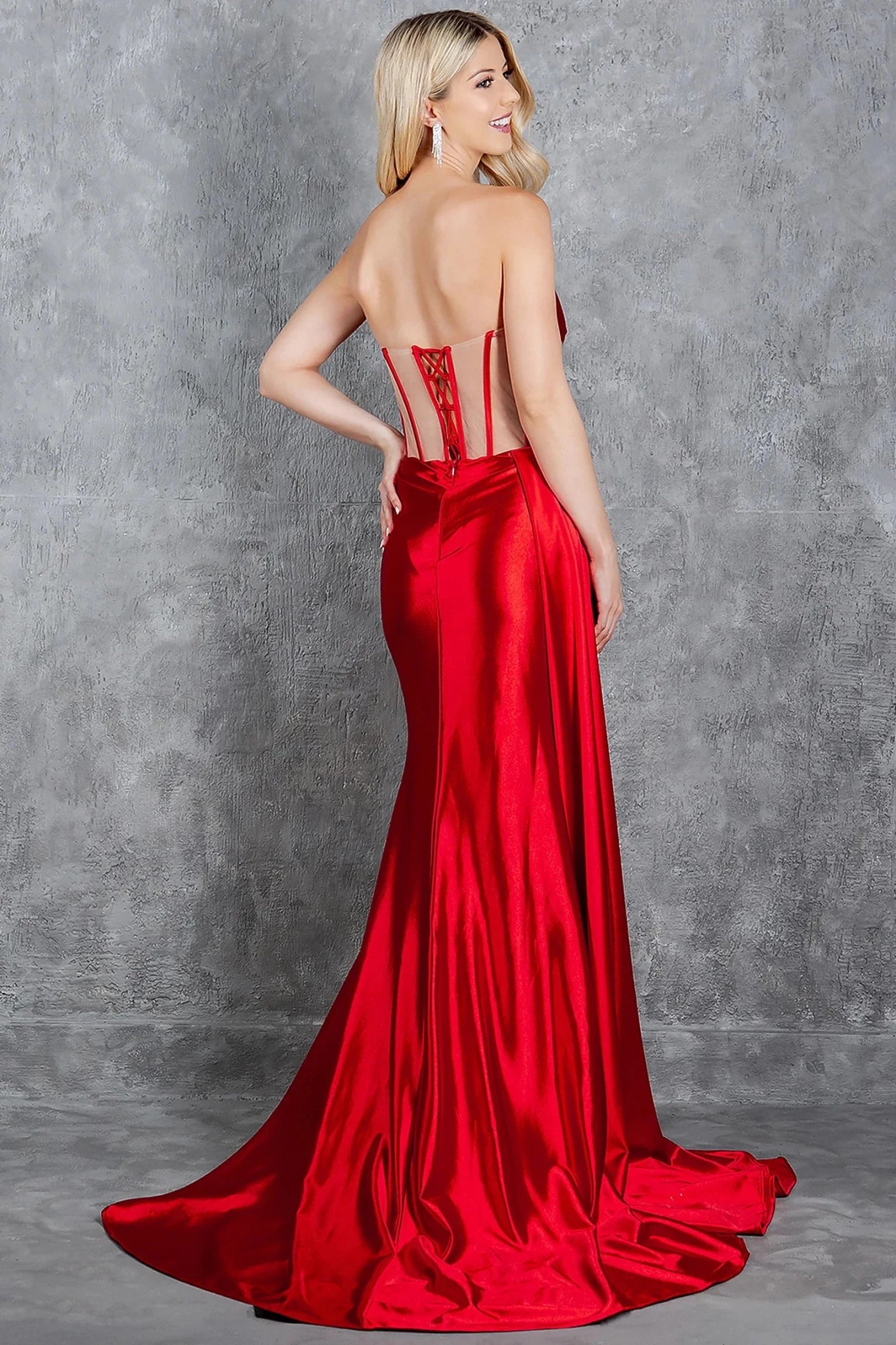Red prom dress styled with sheer cutout details creating corset appearance