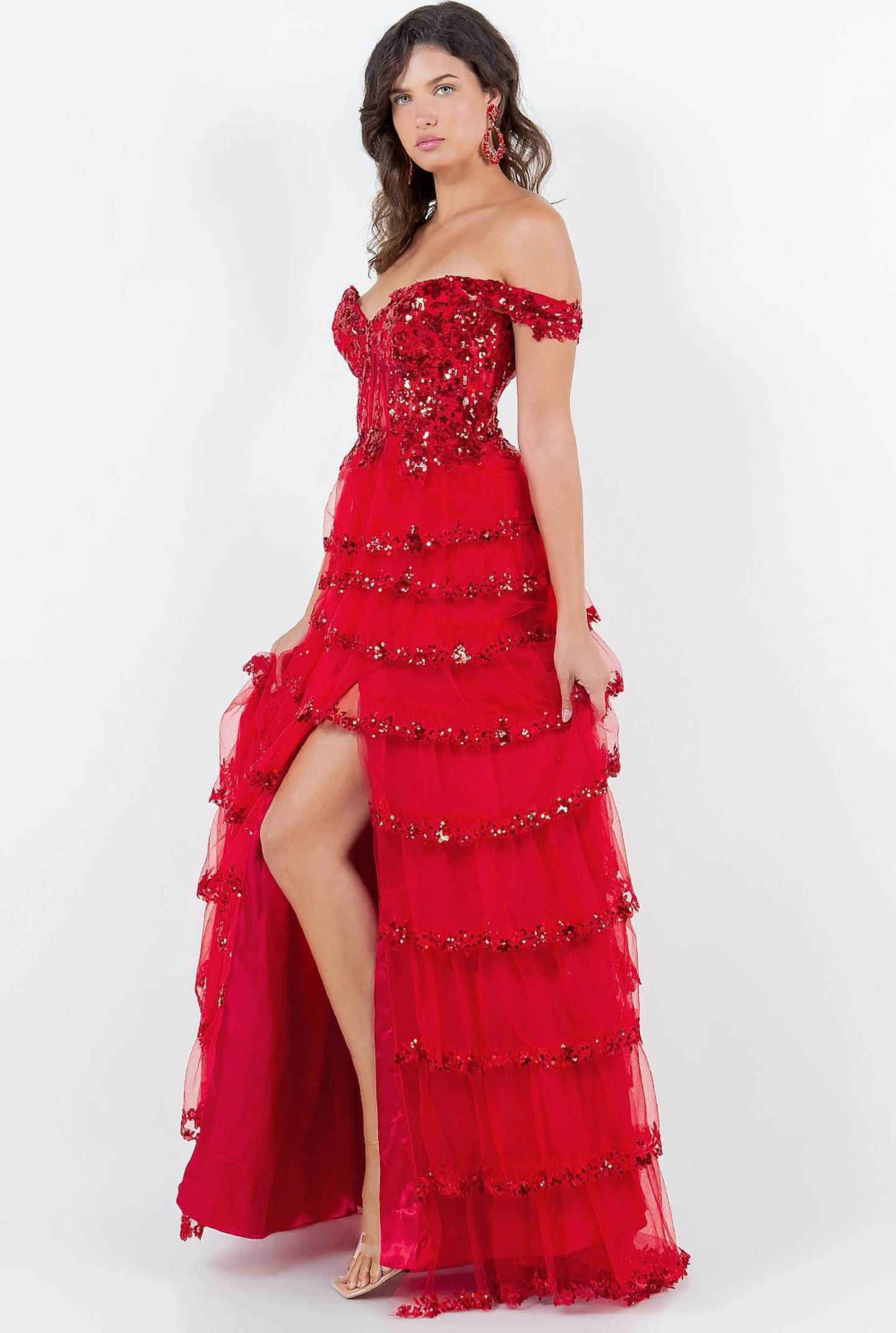 Red prom dress completed with thigh-high slit and side drape
