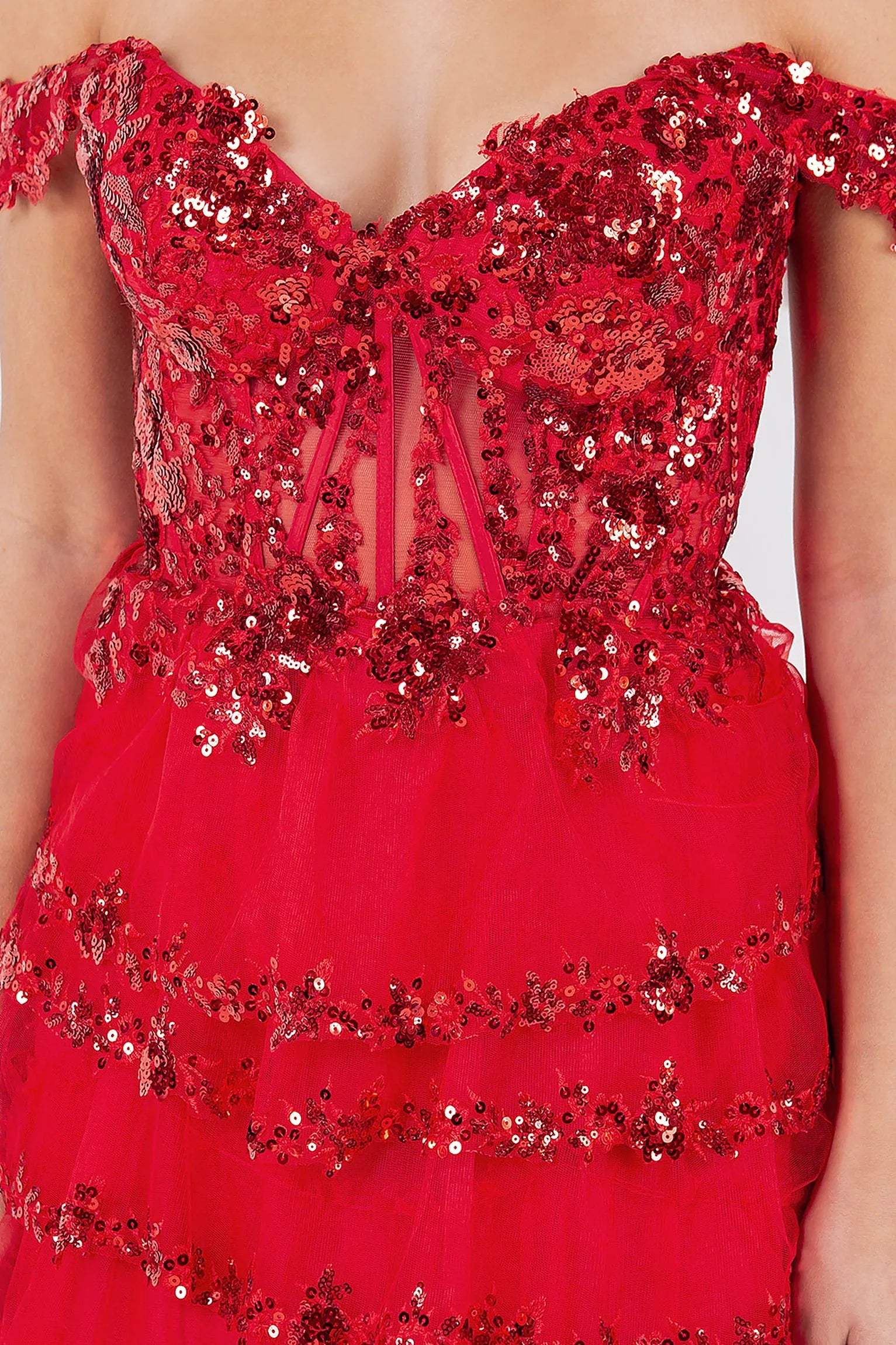 Red prom dress featuring corset bodice with beadwork and sequins