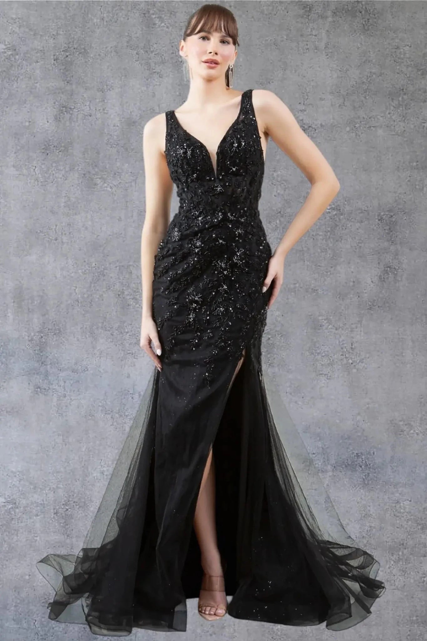 A full-length front view of a woman wearing a black lace formal prom dress with an elegant scoop neckline detail.