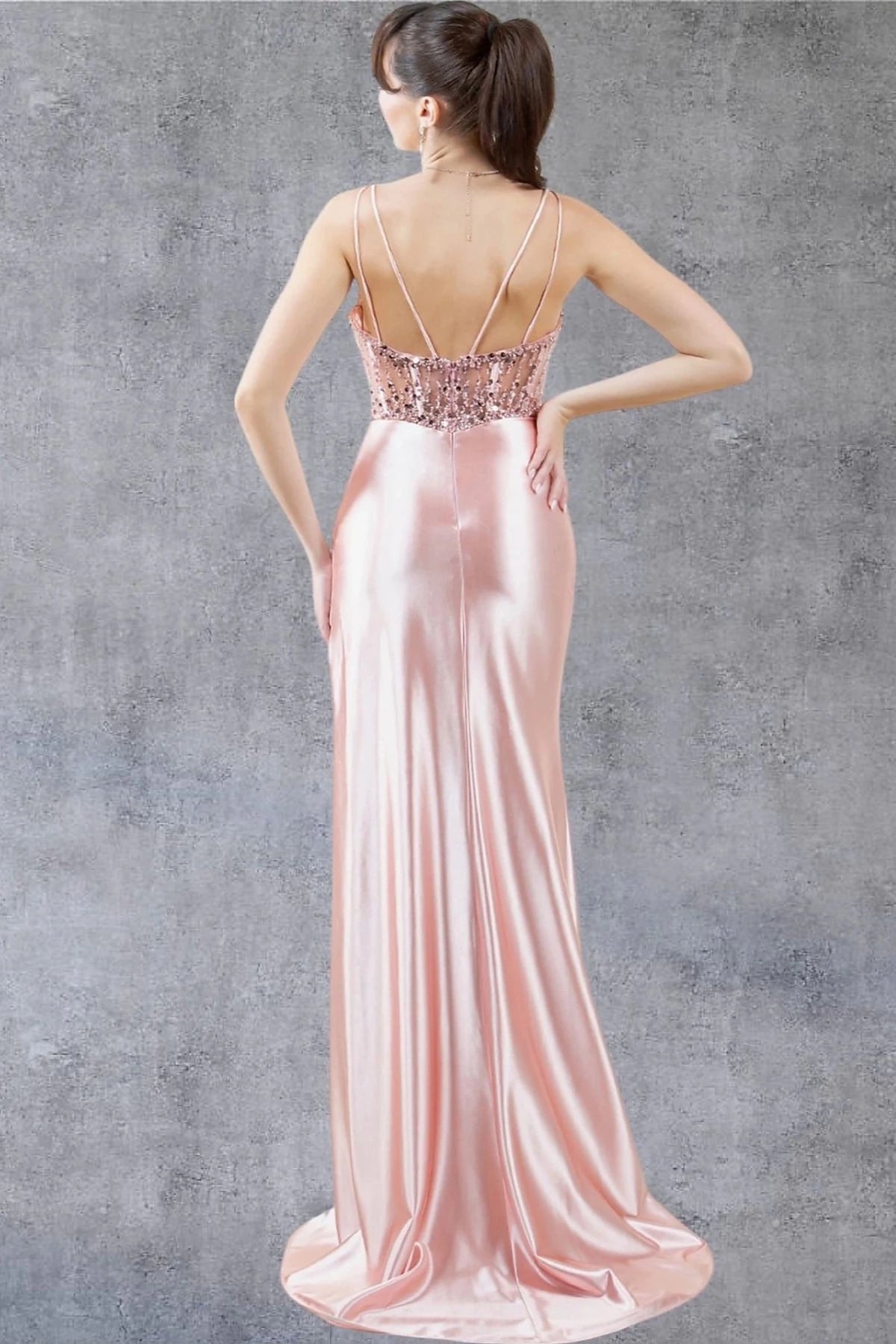 Rear view reveals rose Gold prom dress designed with zipper back closure.