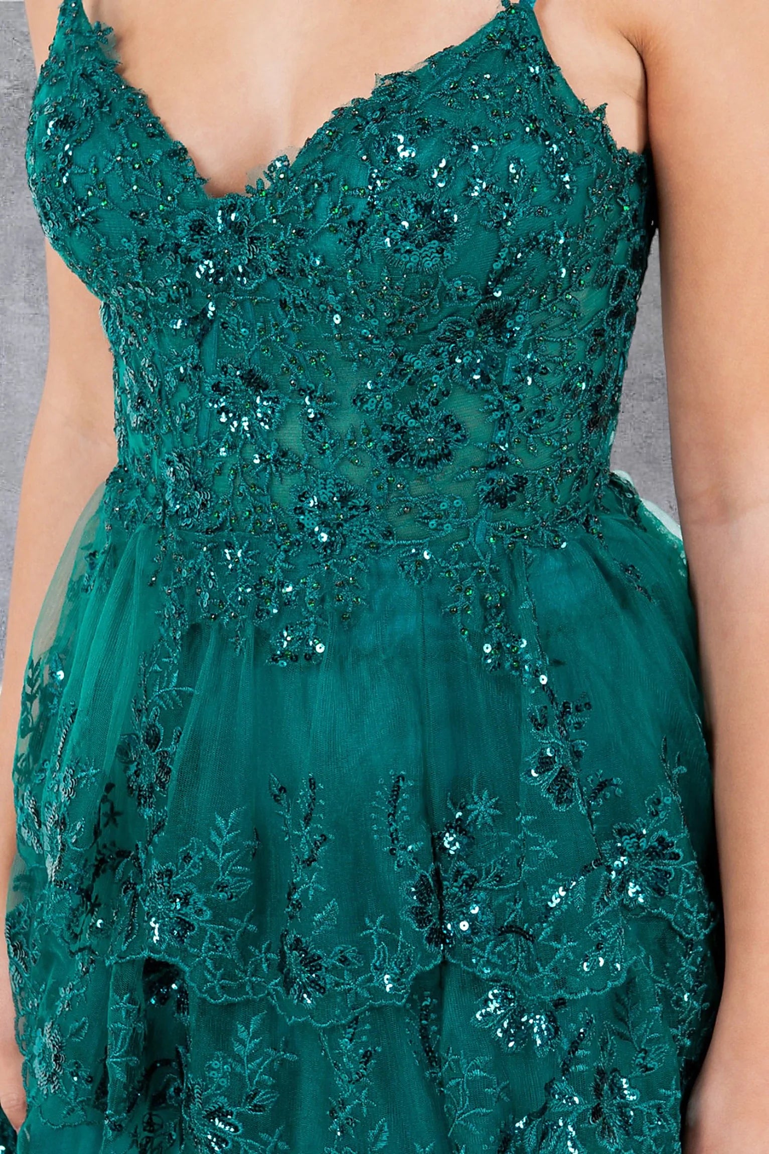 Green prom dress featuring fitted corset bodice with beadwork