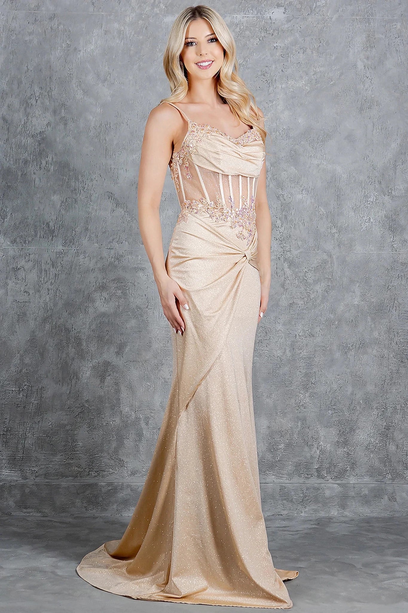 Champagne prom dress styled with spaghetti straps and ruched waist detail
