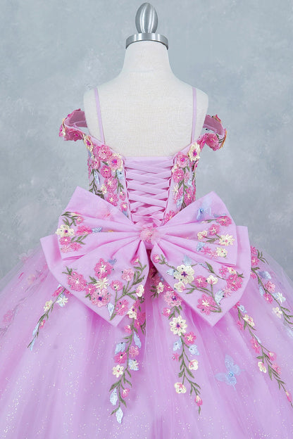 Rear view reveals pink back zoom kids mini quinceañera mini quince dress with multicolor daisy embroidery and large detachable bow.