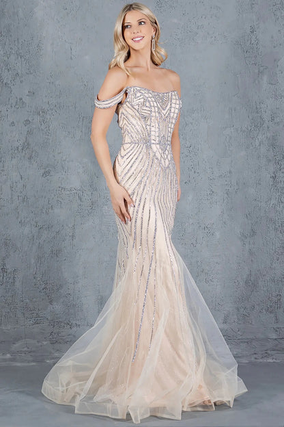 A side profile view of a woman wearing a champagne prom dress, showcasing the flowing silhouette and beadwork.