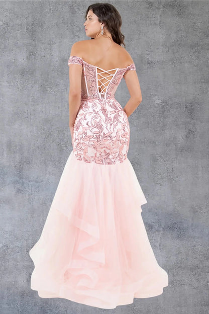 A full back view of a woman wearing a blush formal dress with a lace-up corset and layered mermaid tulle skirt.