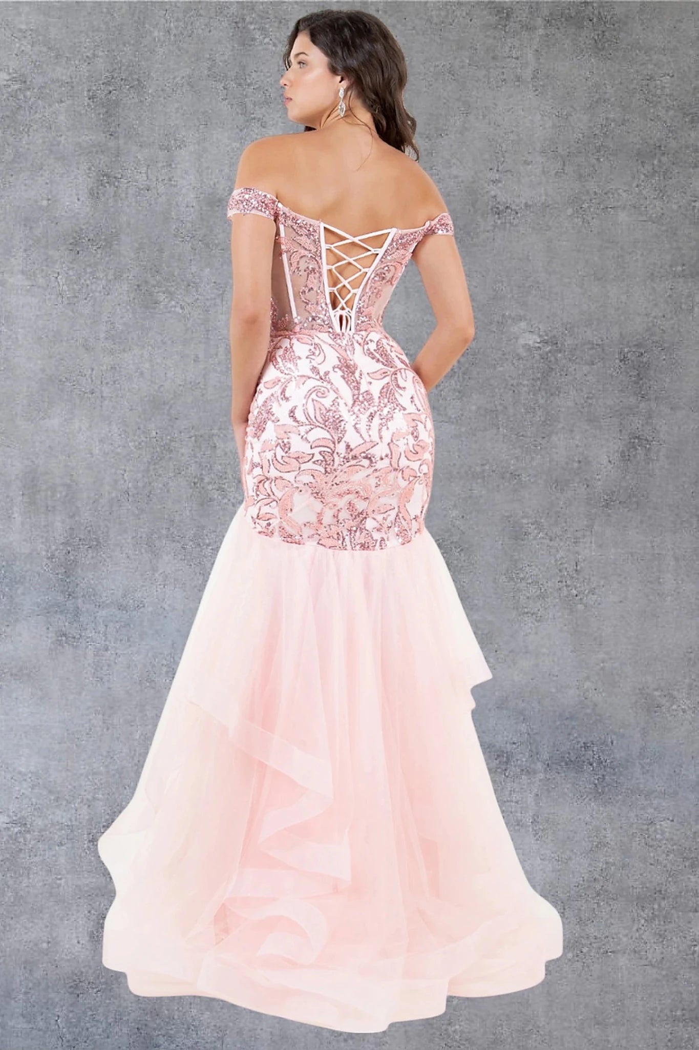 Blush evening dress completed with lace-up back and zipper closure