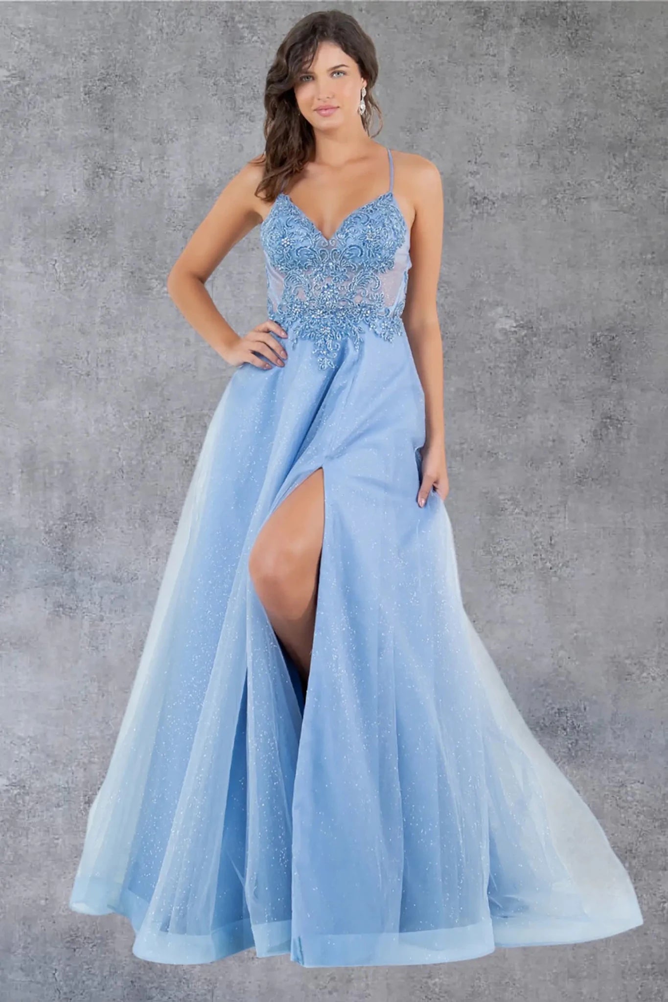 Full front view of a women wearing blue A-line prom dress with lace bodice, V-neckline, and glitter fabric.