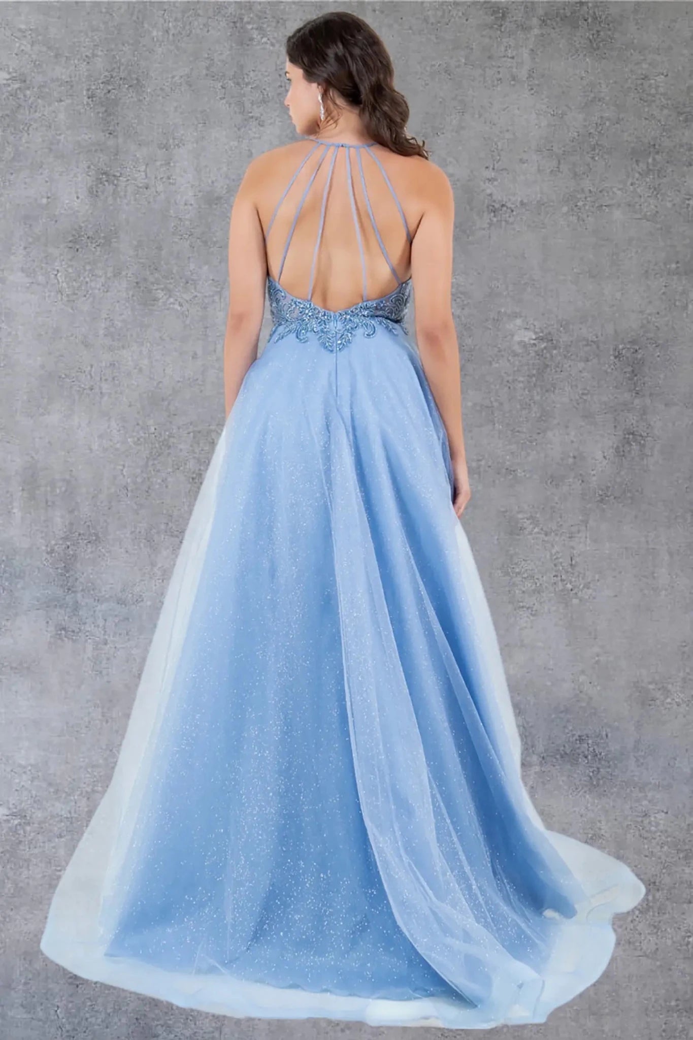 Full back view of blue formal dress with open back and strap detail.