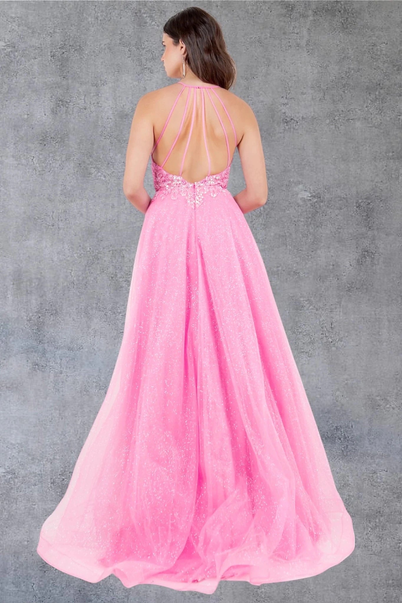 Hot pink prom dress completed with open back straps and zipper closure