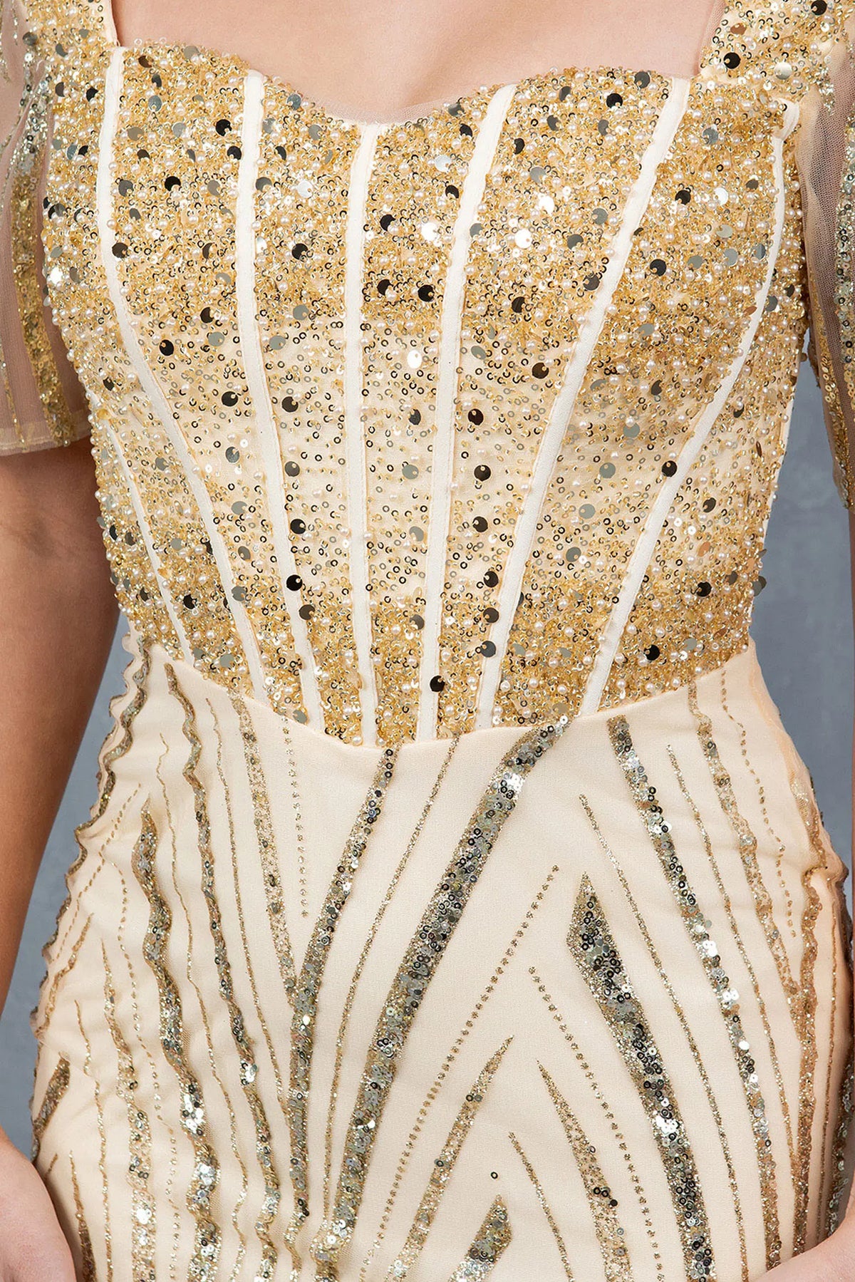 Intricate beadwork frames the square neckline of this Champagne mother of the bride dress.