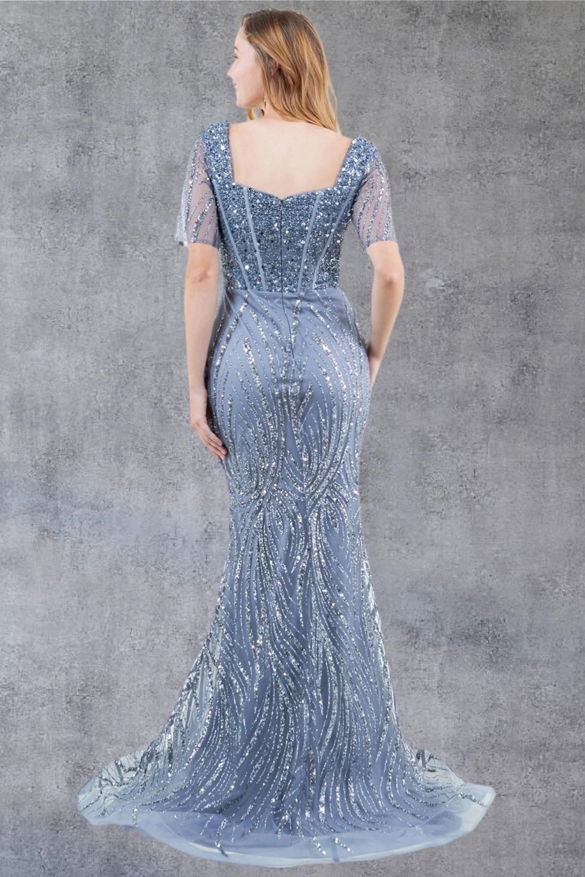 Behind the Dusty Blue mother of the bride dress, a square back leads into the sparkling train.