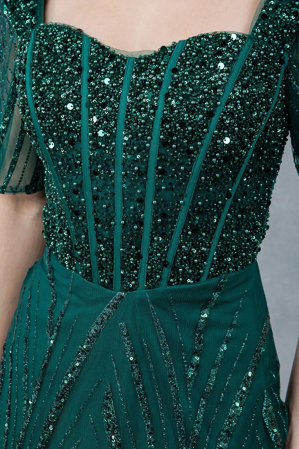 Detailed Hunter Green mother of the bride dress reveals sheer sleeves and a structured sequin bodice.