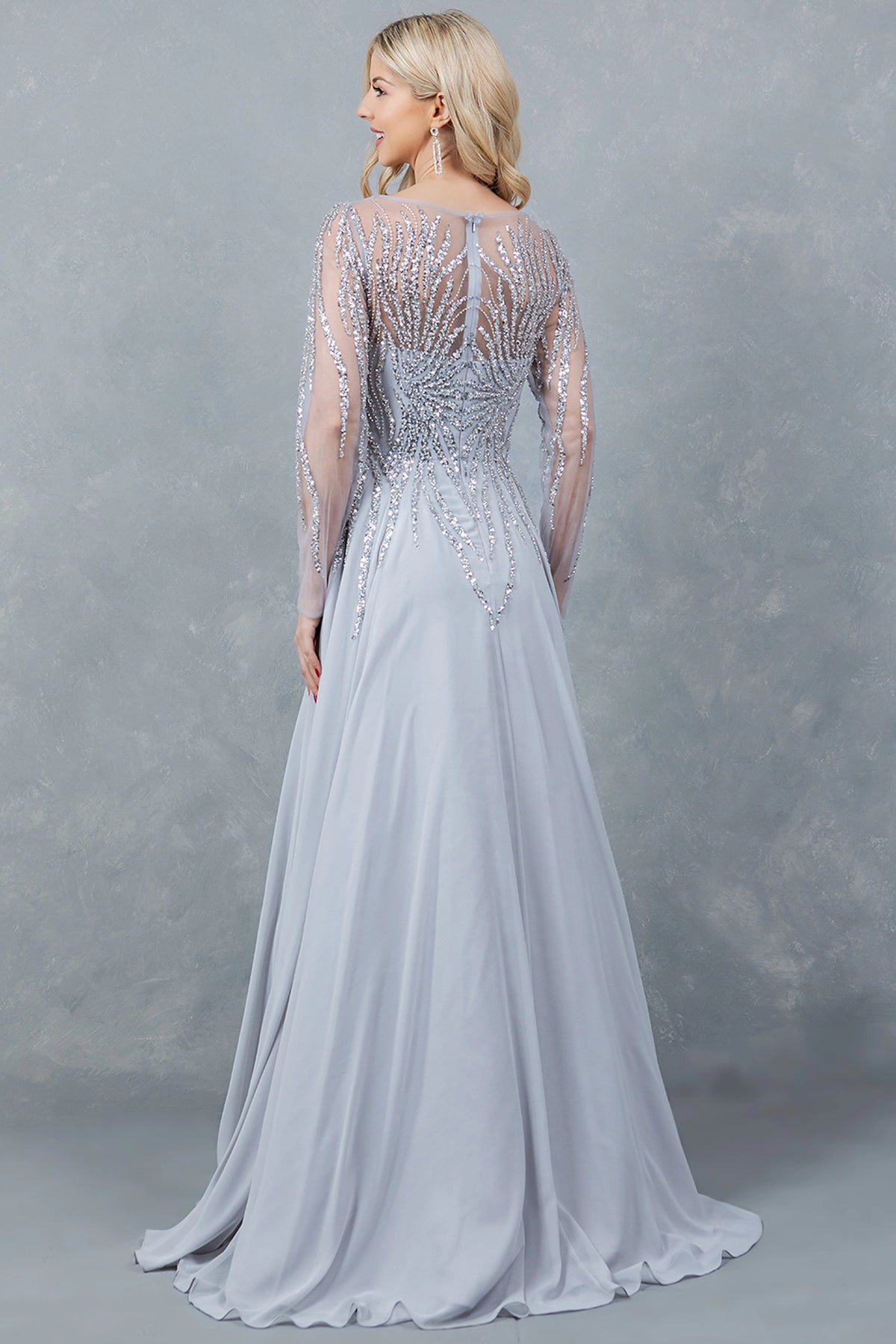 From the back, the Silver mother of the bride dress reveals sheer embellishment and a soft skirt.