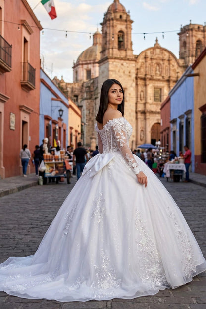 Shown in a angled view, the Off White quinceañera dress has long lace sleeves and floral appliques over a full ball skirt.